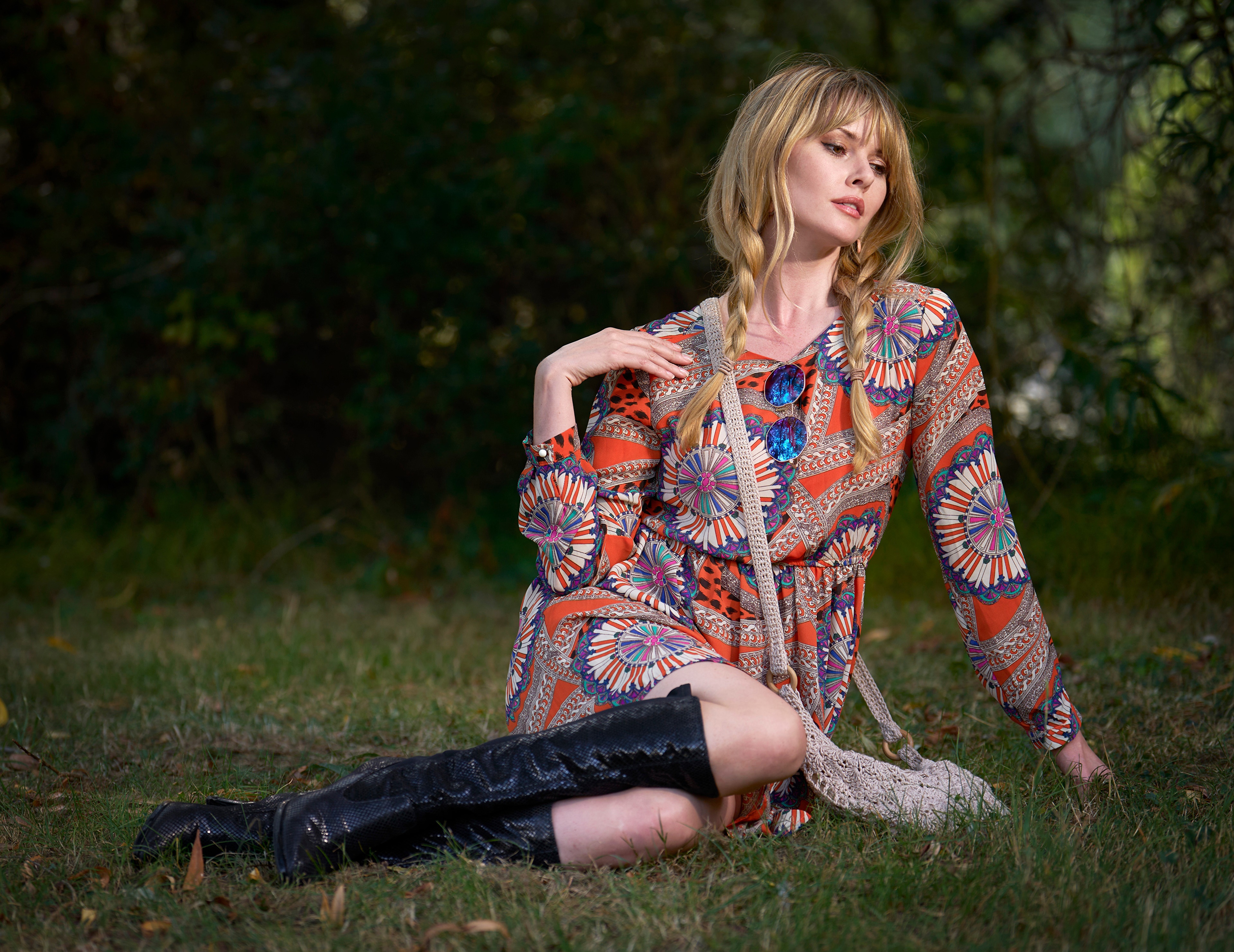 Blonde girl sitting on grass wearing boots and dress HD Wallpaper