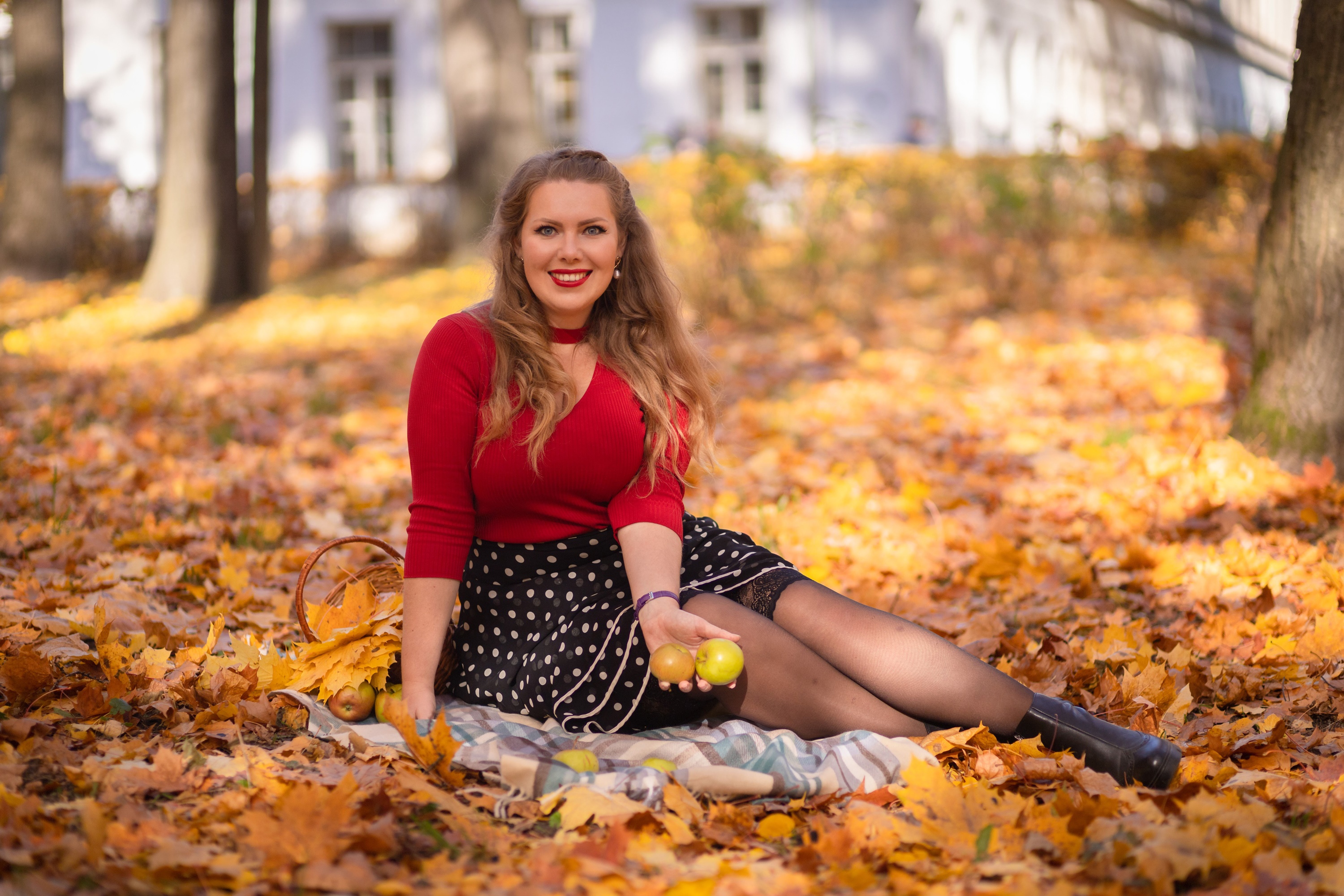 Woman in red top and polka dot skirt with apples in autumn HD Wallpaper
