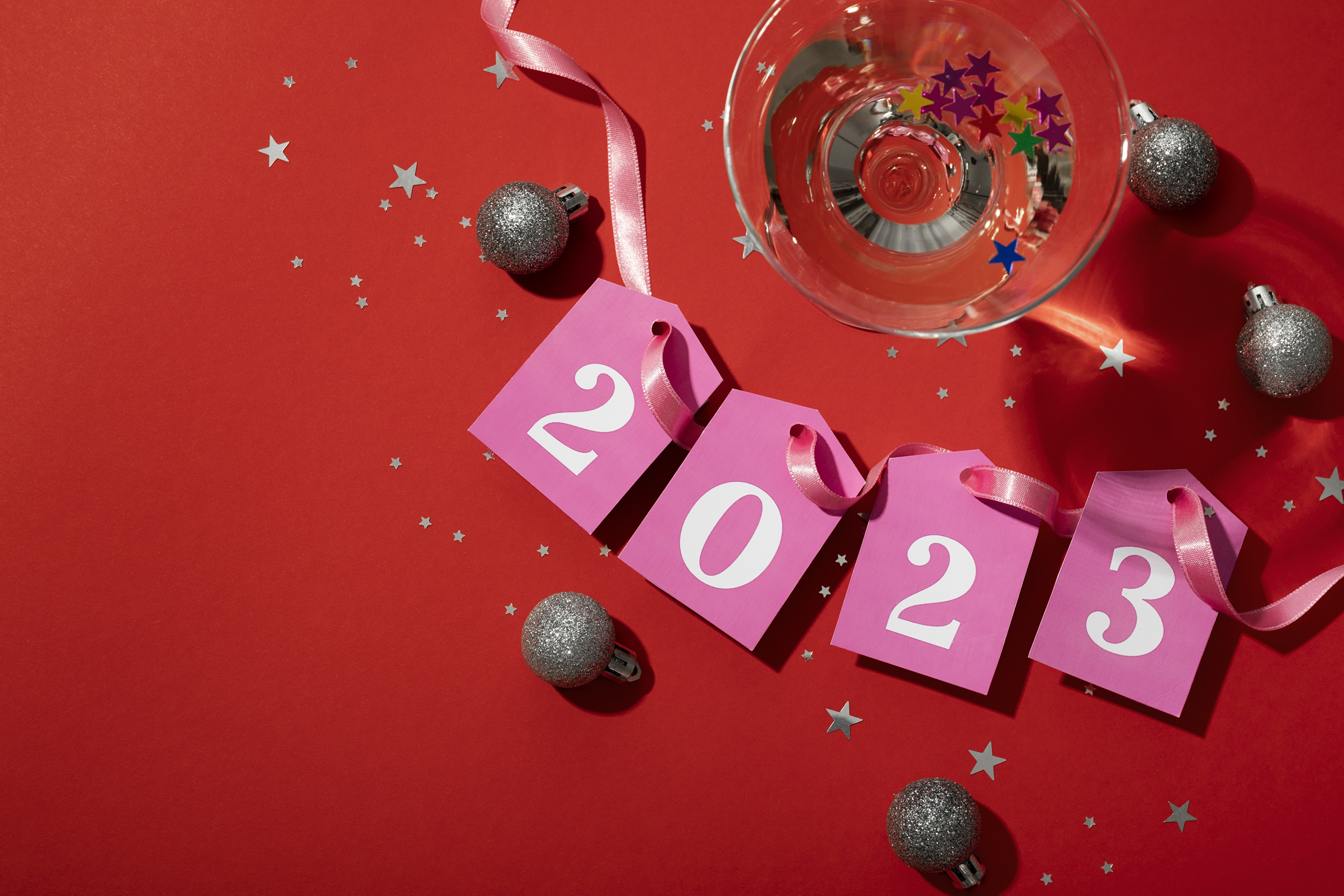 New Year 2023 celebration with ornaments and cocktail HD Wallpaper