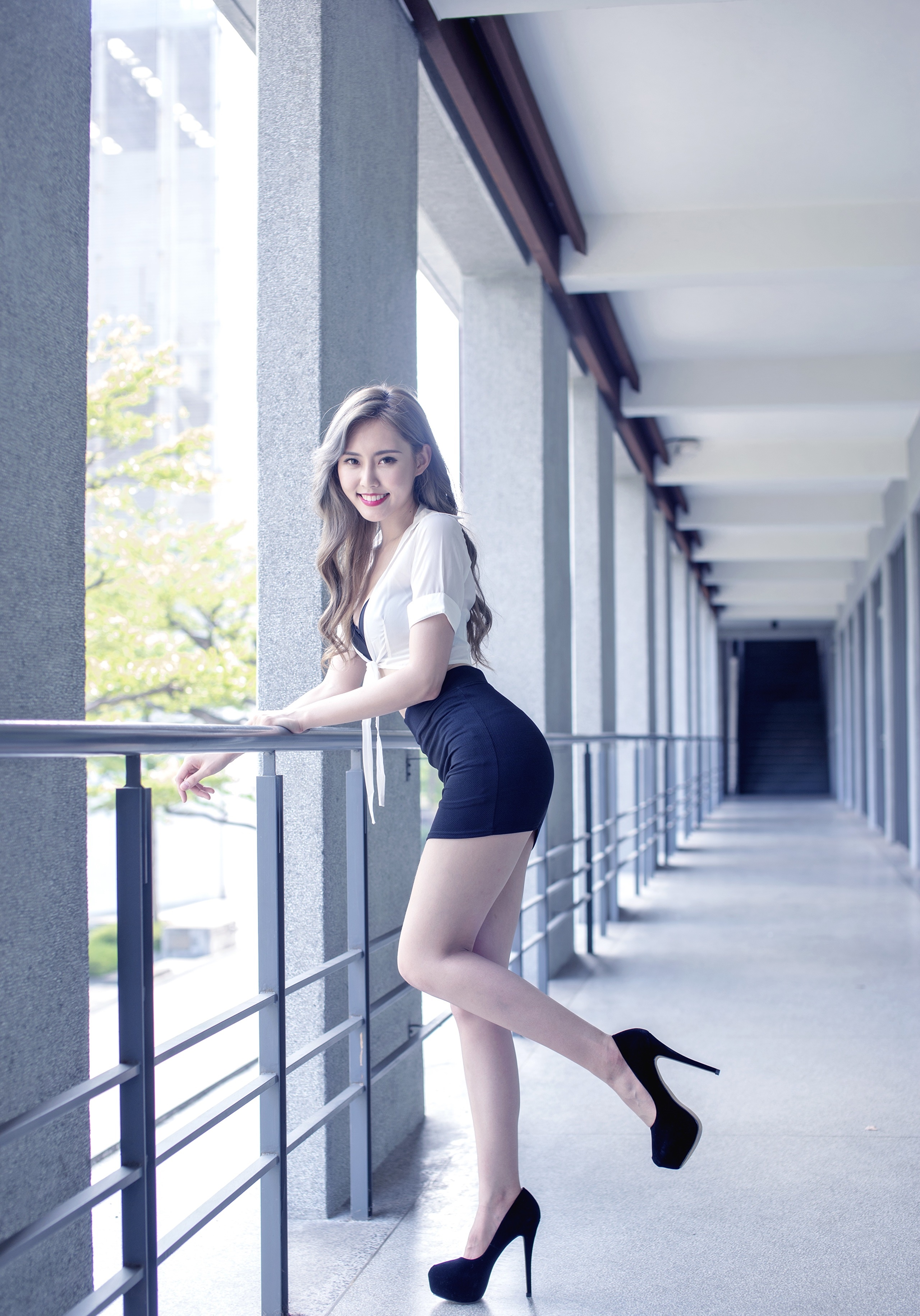 Asian woman in white top and black skirt posing outdoors HD Phone Wallpaper