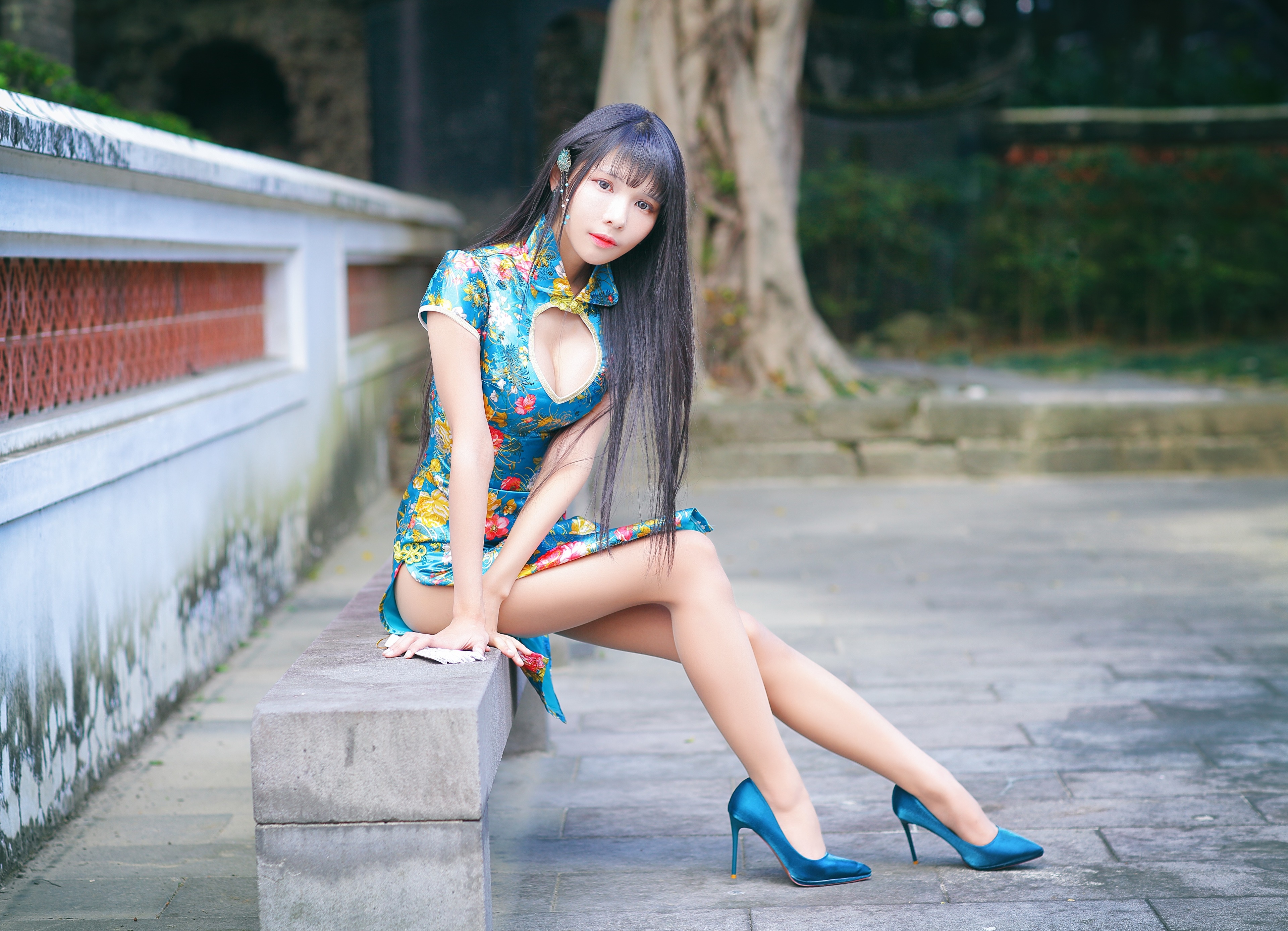 Asian woman in floral dress sitting on bench HD Wallpaper