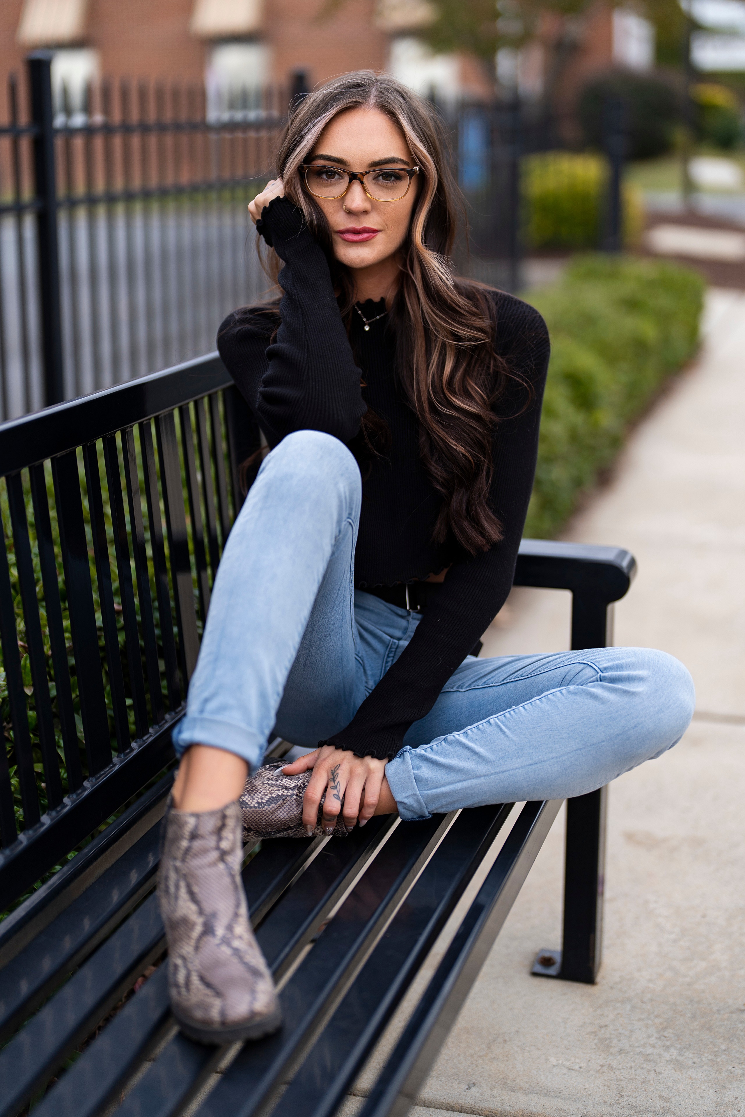 Woman with glasses sitting on a bench HD Phone Wallpaper
