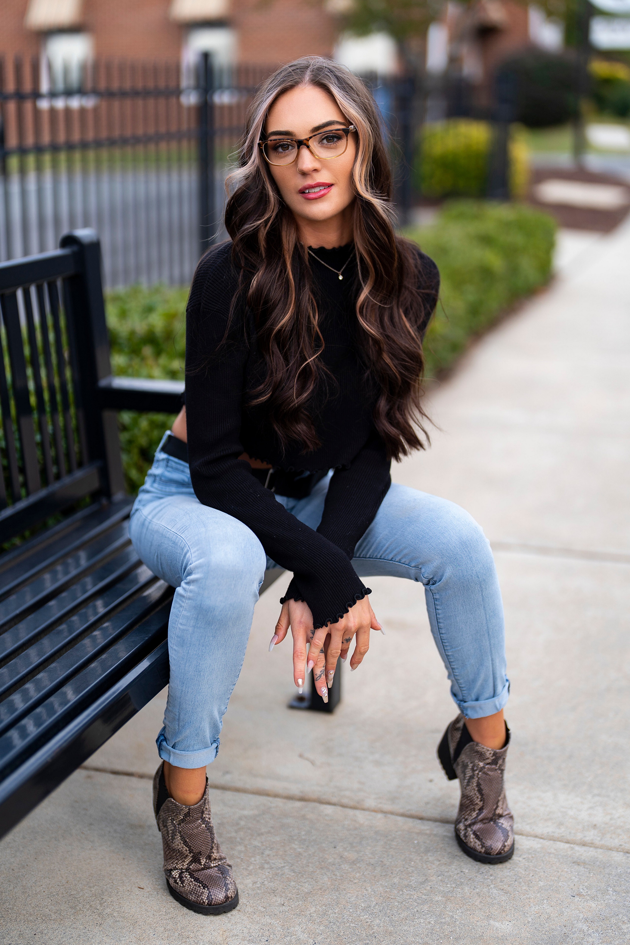 Woman with glasses sitting on a bench HD Phone Wallpaper