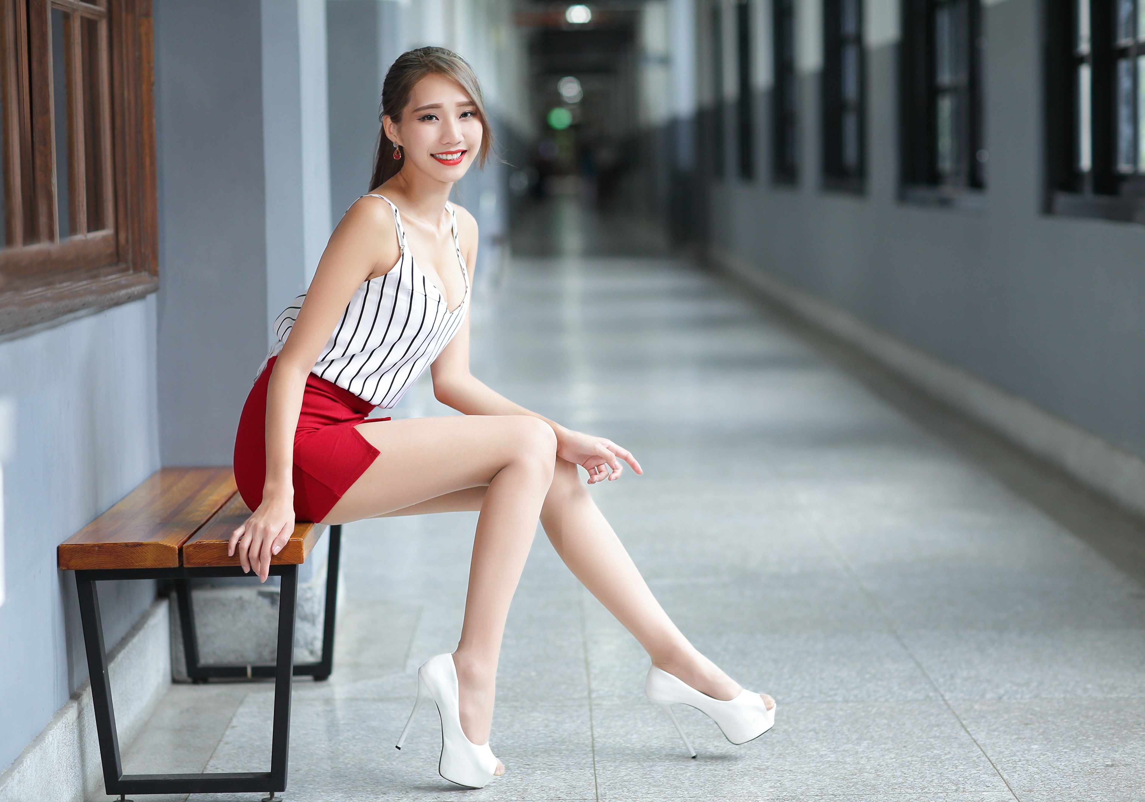 Asian Woman in Striped Top and Red Skirt Sitting on Bench HD Wallpaper