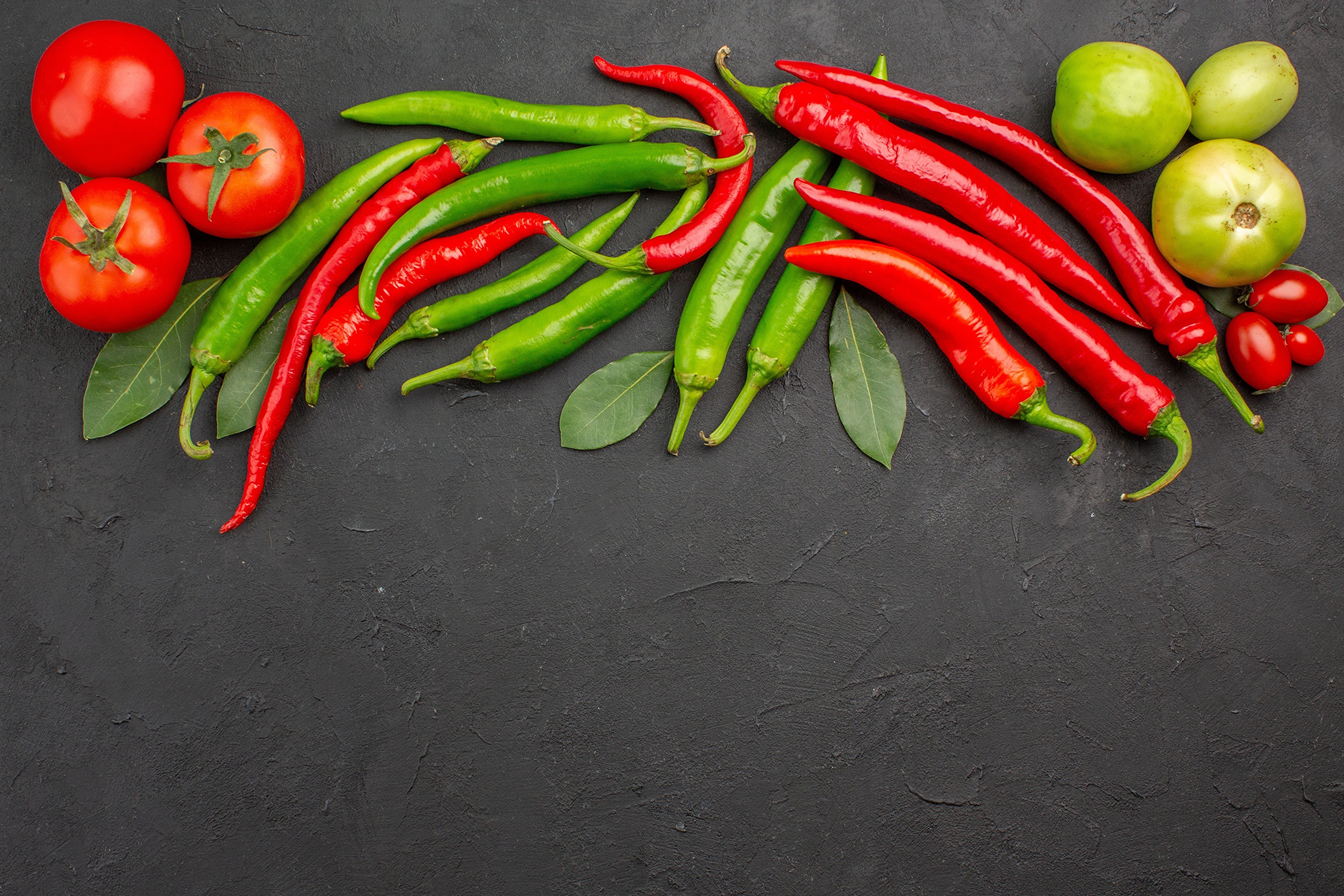 Tomatoes and chili peppers on a dark surface HD Wallpaper