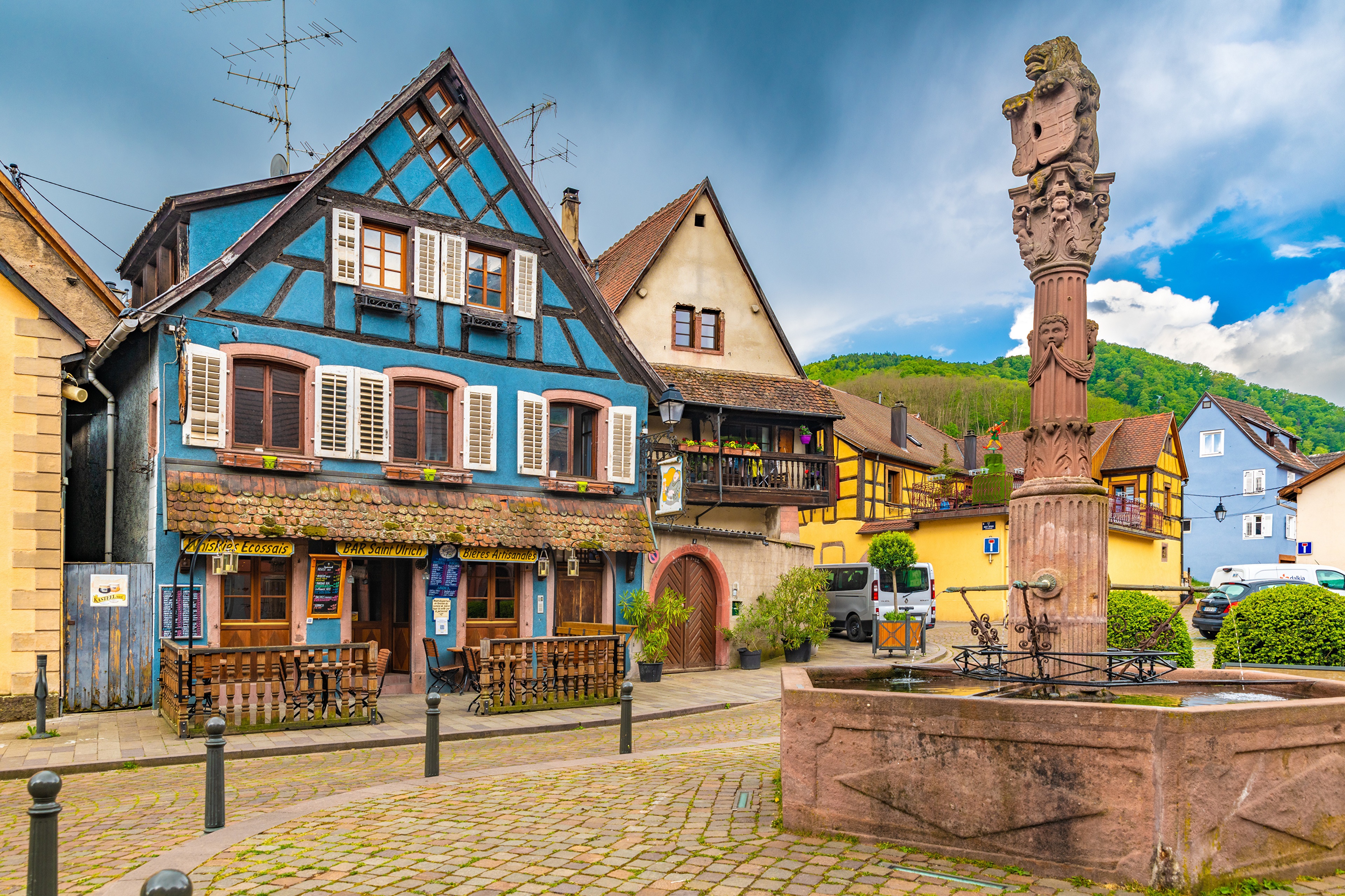 Half-timbered houses and fountain in France HD Wallpaper