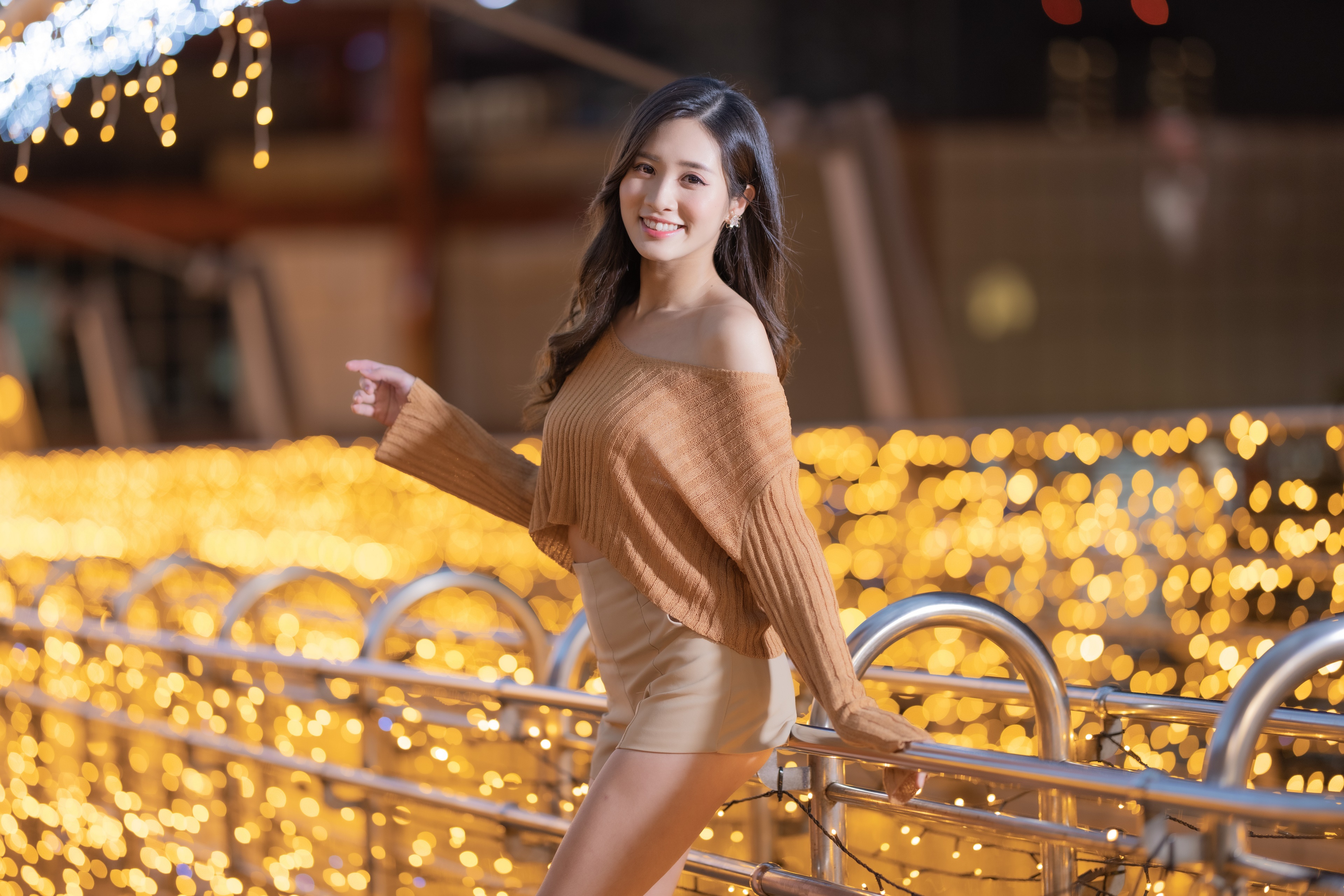 Asian woman smiling in off-shoulder sweater and shorts HD Wallpaper
