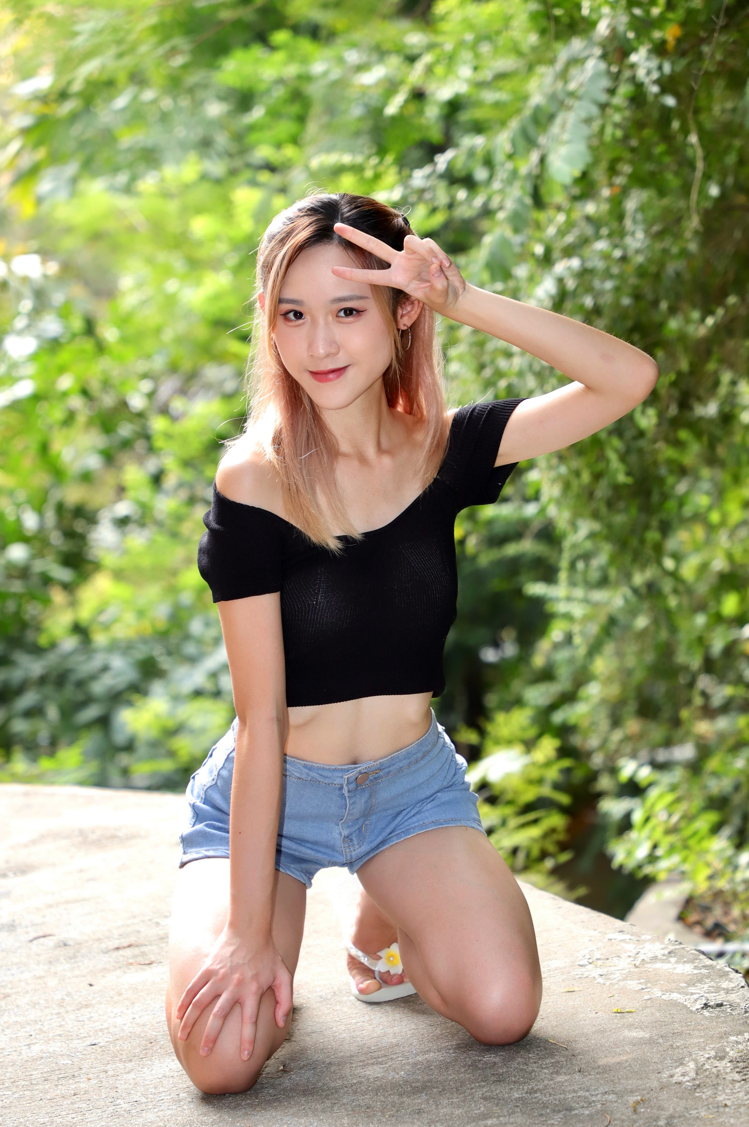 Asian woman in shorts and off-the-shoulder top posing outdoors HD Phone Wallpaper