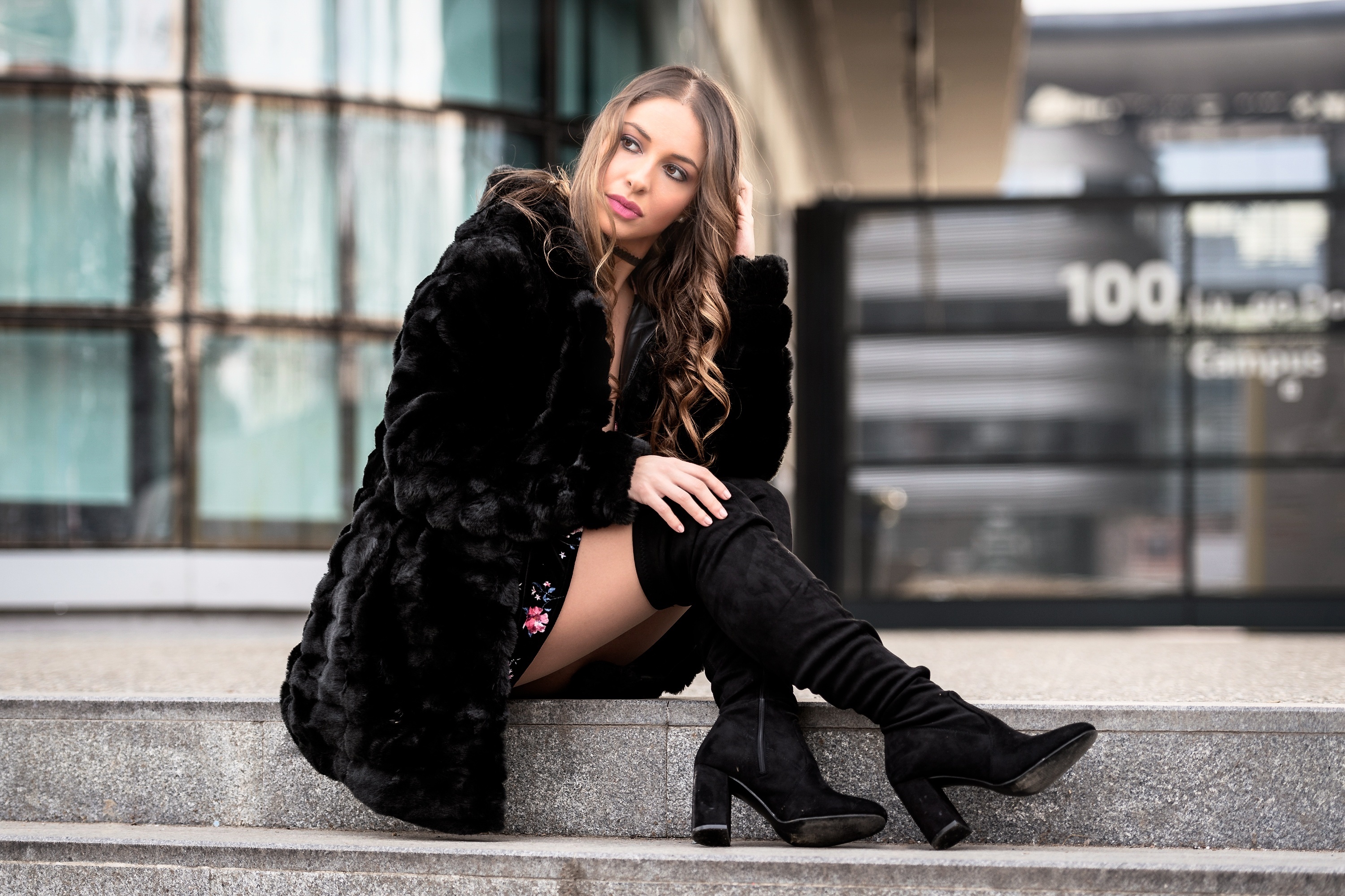 Woman in fur coat and boots sitting on steps HD Wallpaper