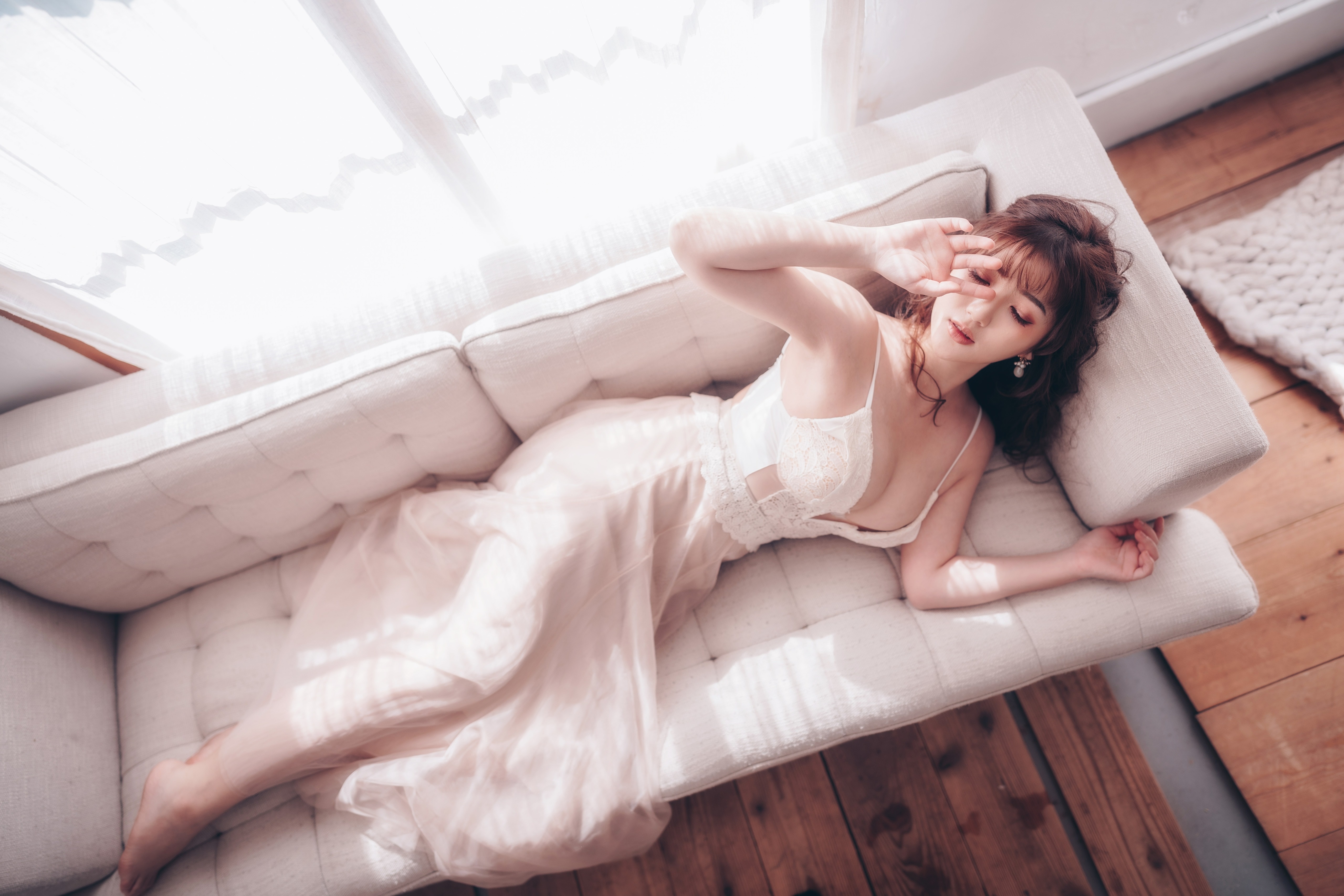 Brunette girl in lingerie lying on a sofa HD Wallpaper