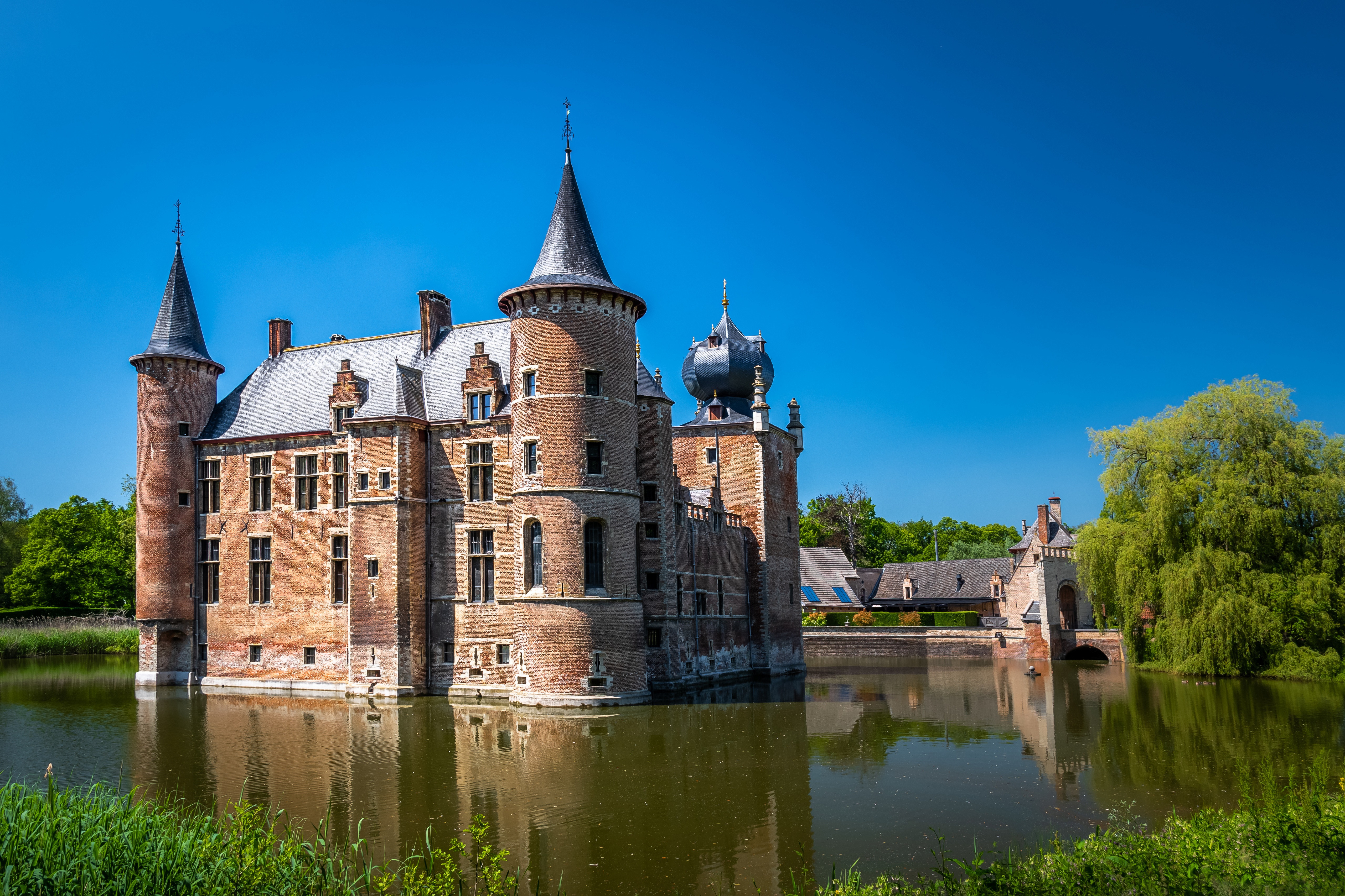 Castle with towers surrounded by a pond in Aartselaar, Belgium HD Wallpaper