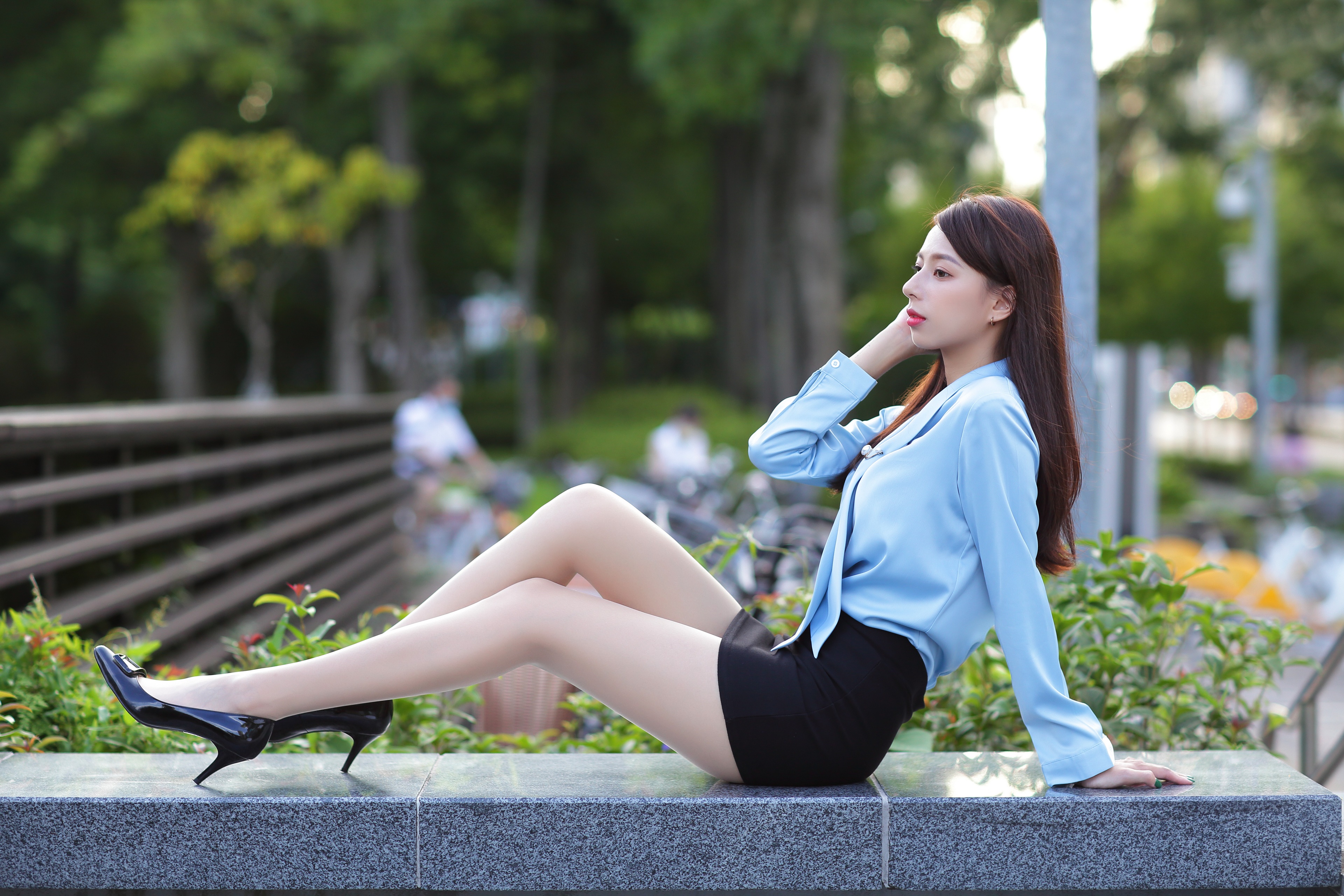 Asian woman in blue blouse and black skirt sitting HD Wallpaper