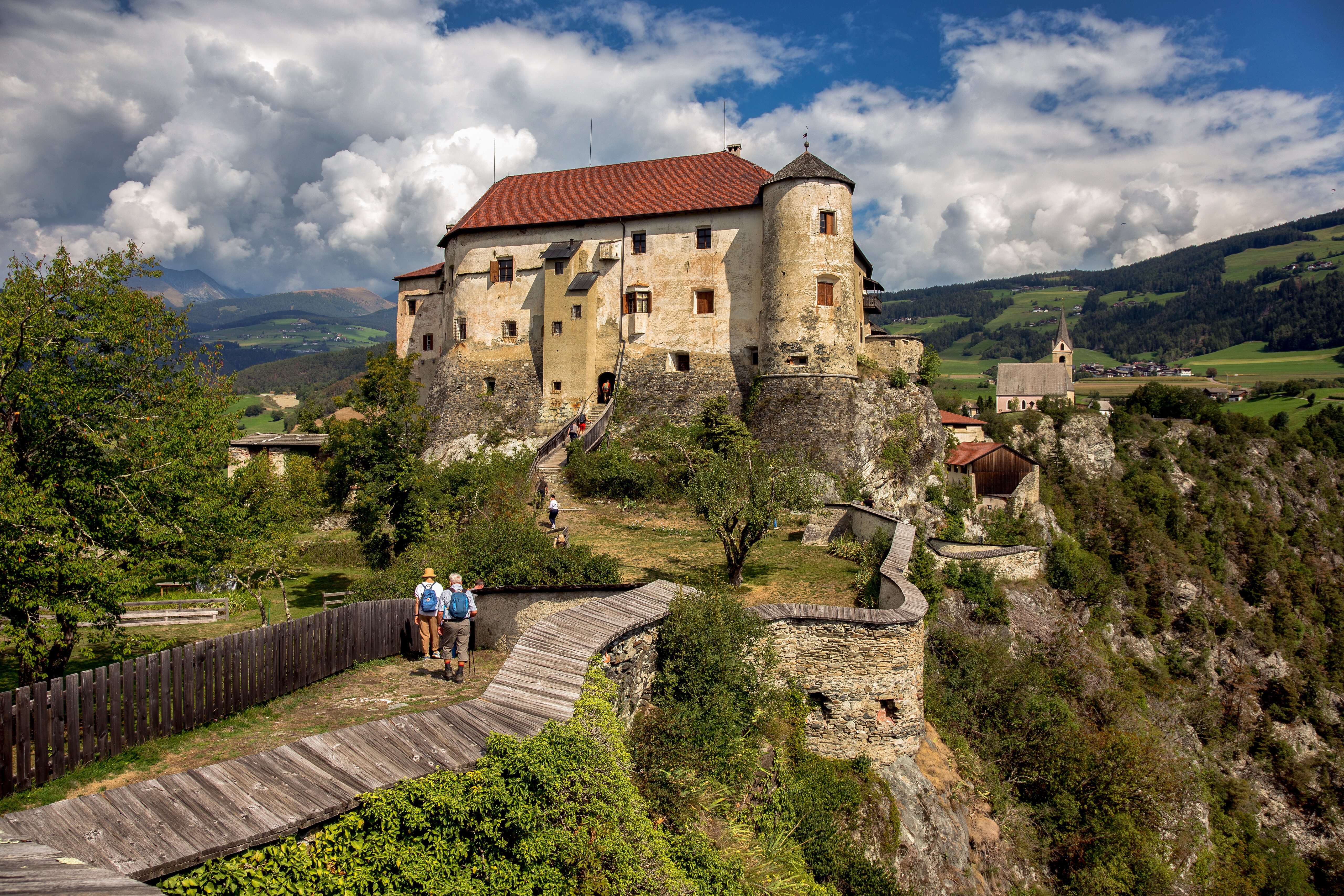 Rodengo Castle in Italy with mountains and a church HD Wallpaper