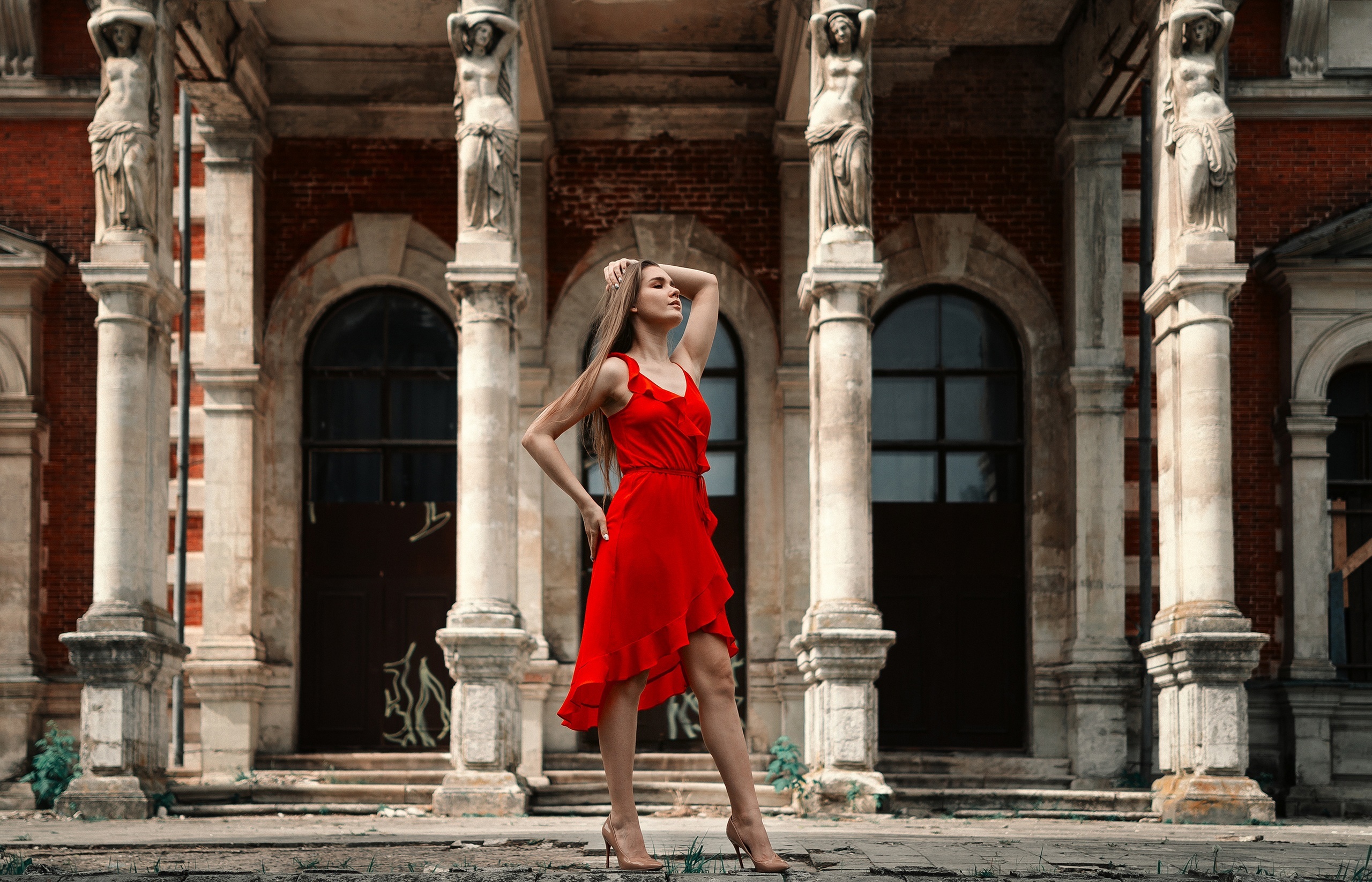 Woman in red dress posing near columns HD Wallpaper
