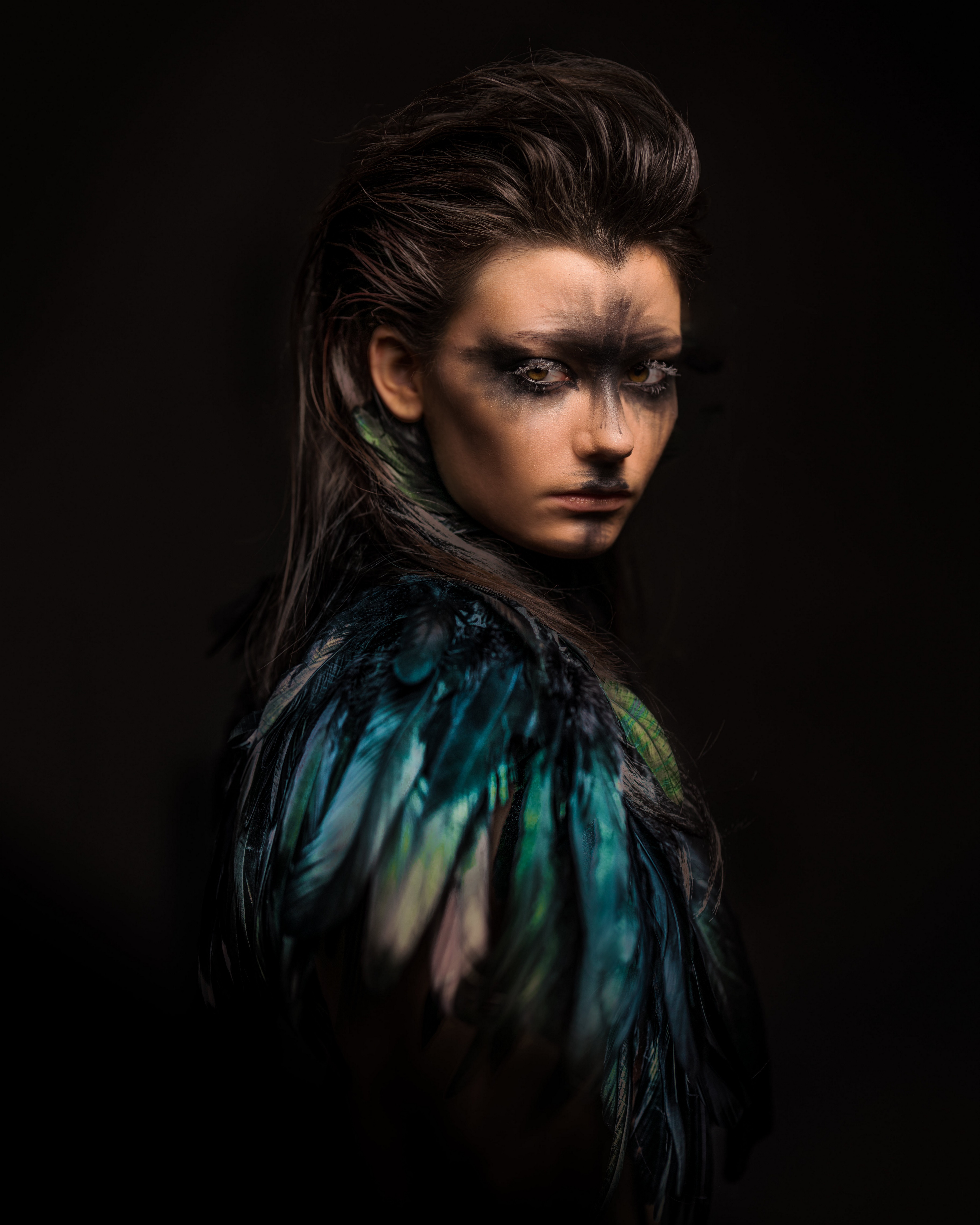 Woman with dramatic makeup and feather accessory HD Phone Wallpaper