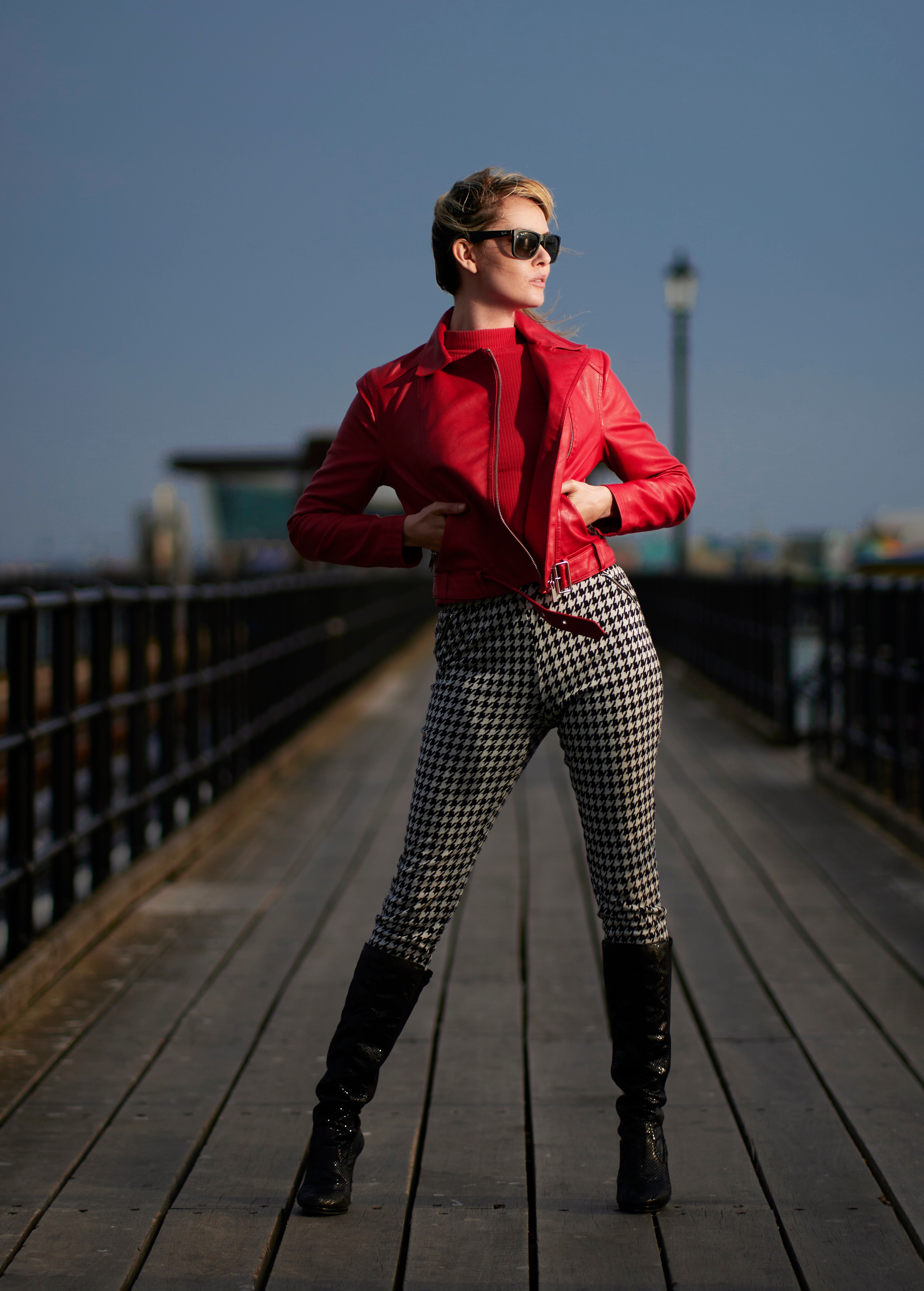 Carla Monaco wearing a red jacket and houndstooth pants HD Phone Wallpaper