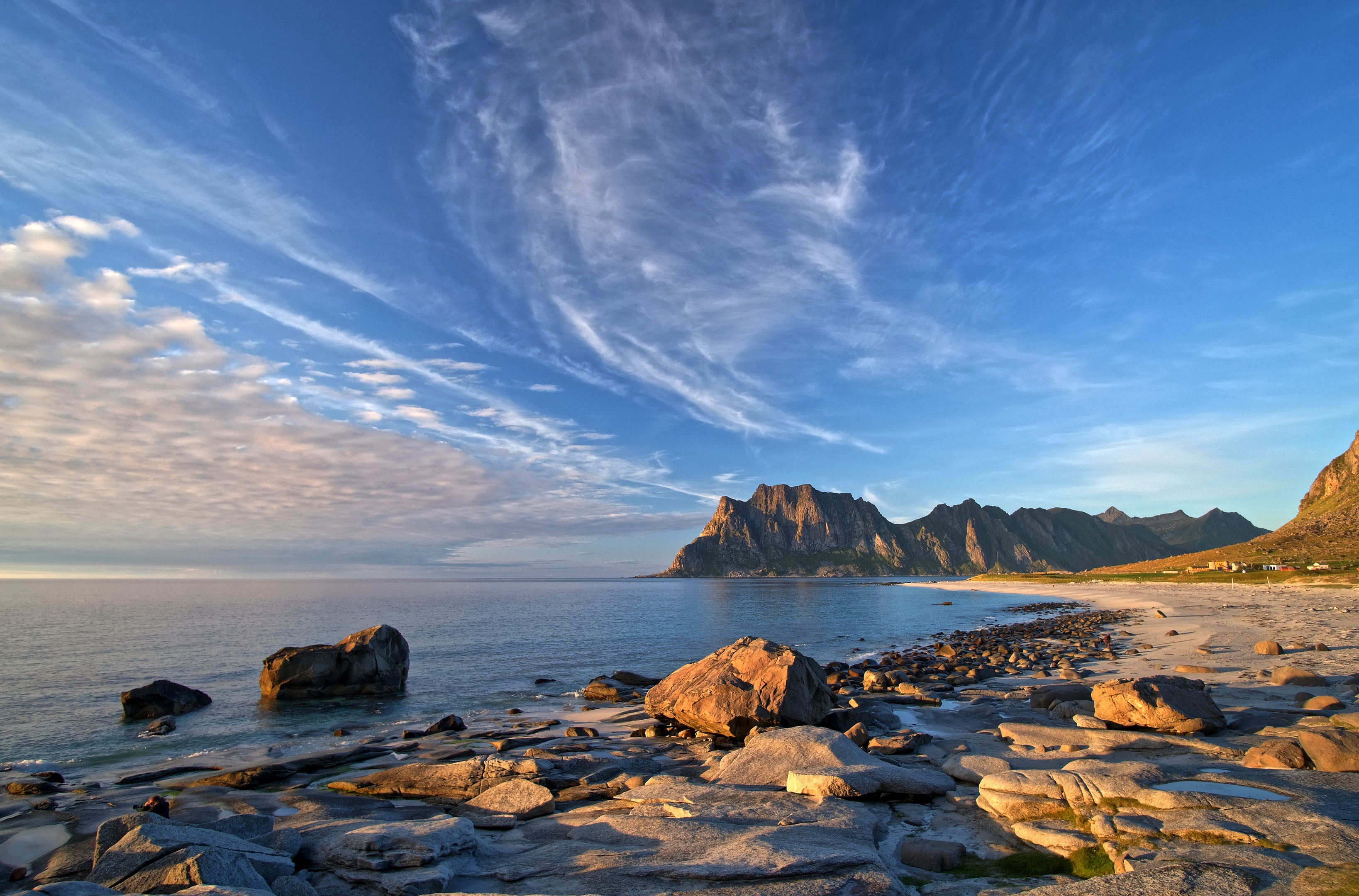 Rocky beach and mountains under a cloudy sky in Lofoten, Norway HD Wallpaper
