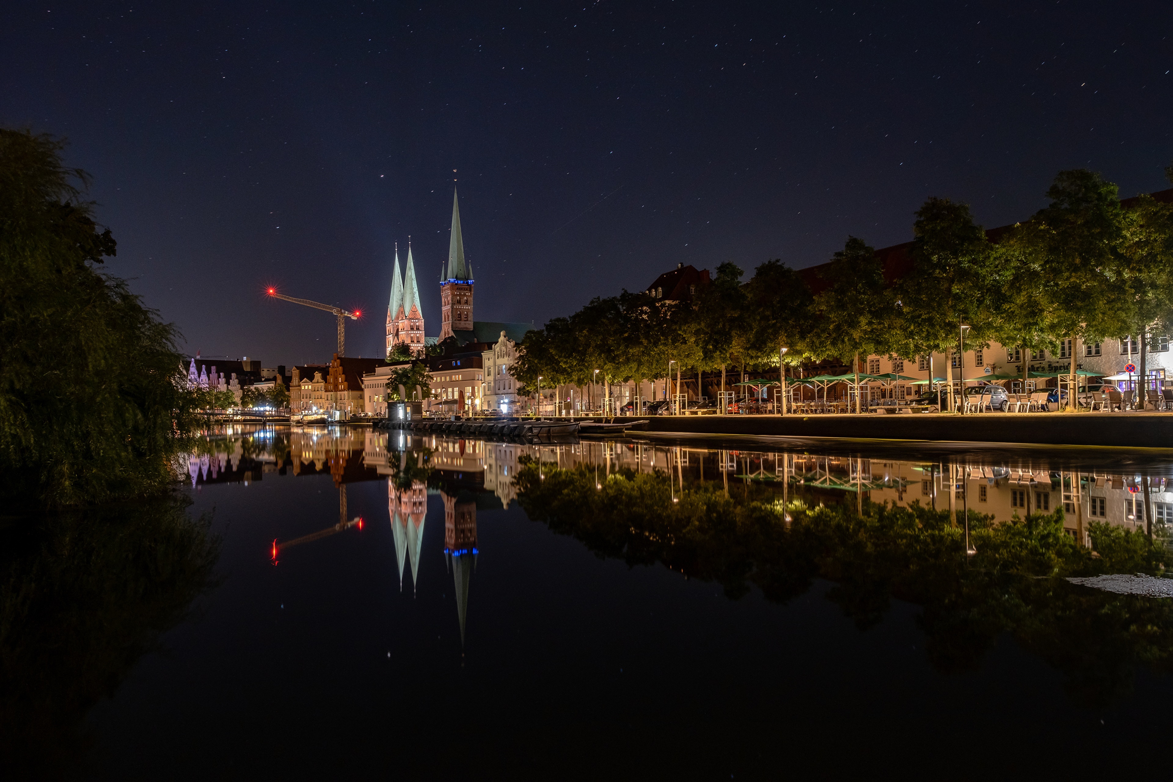 Night view of Lübeck Cathedral reflected in the Trave river HD Wallpaper
