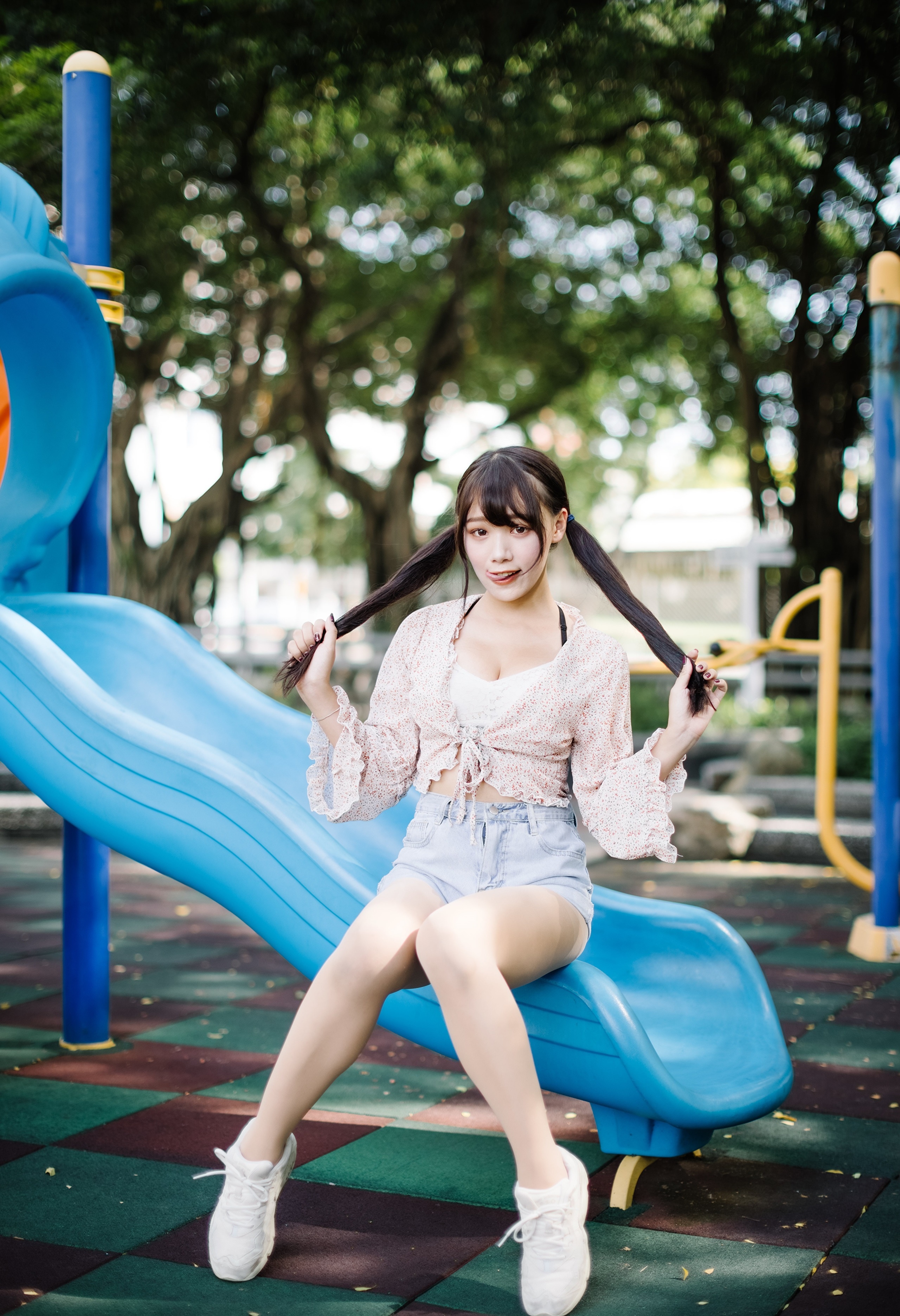 Asian girl with pigtails sitting on a slide HD Phone Wallpaper