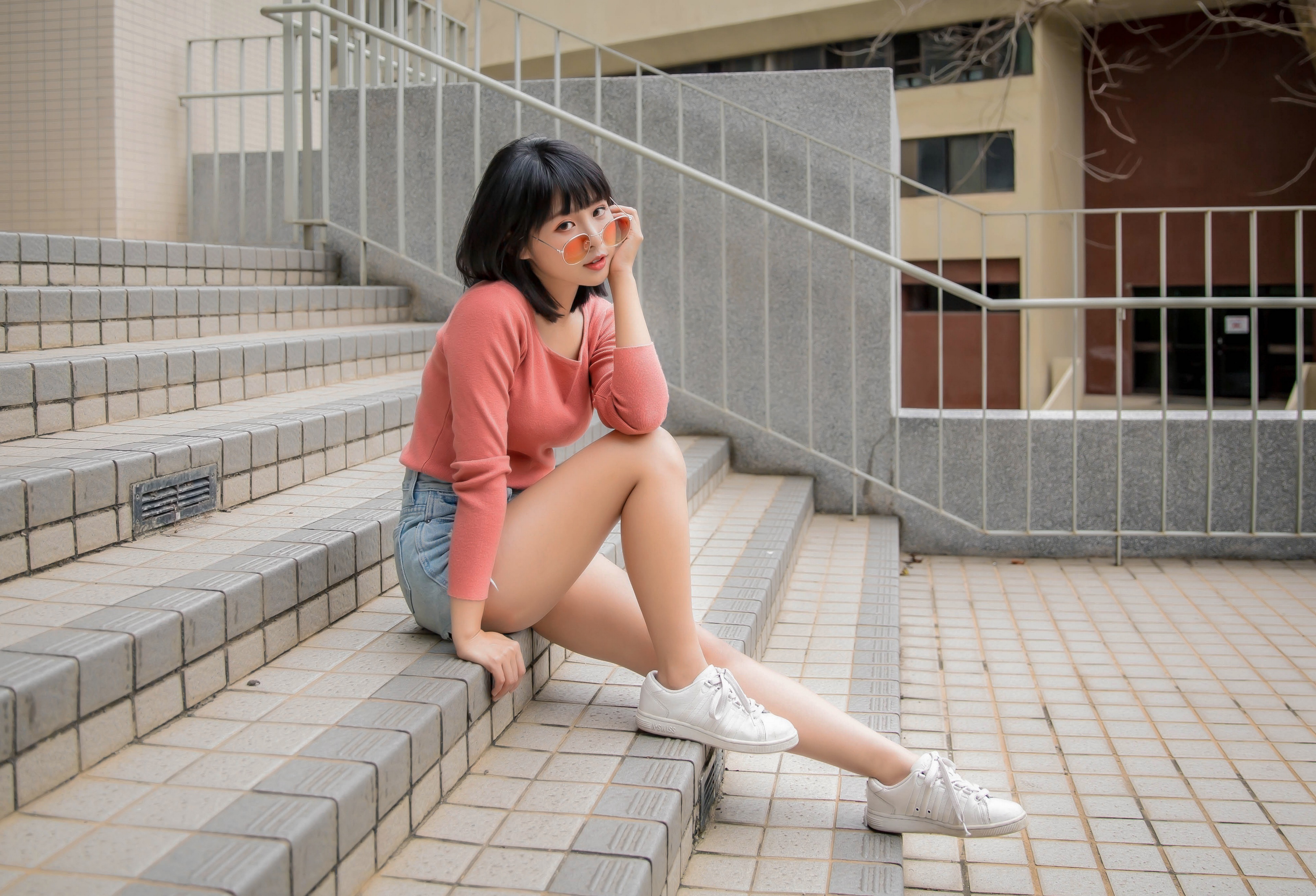 Asian girl in sweater and shorts sitting on stairs HD Wallpaper