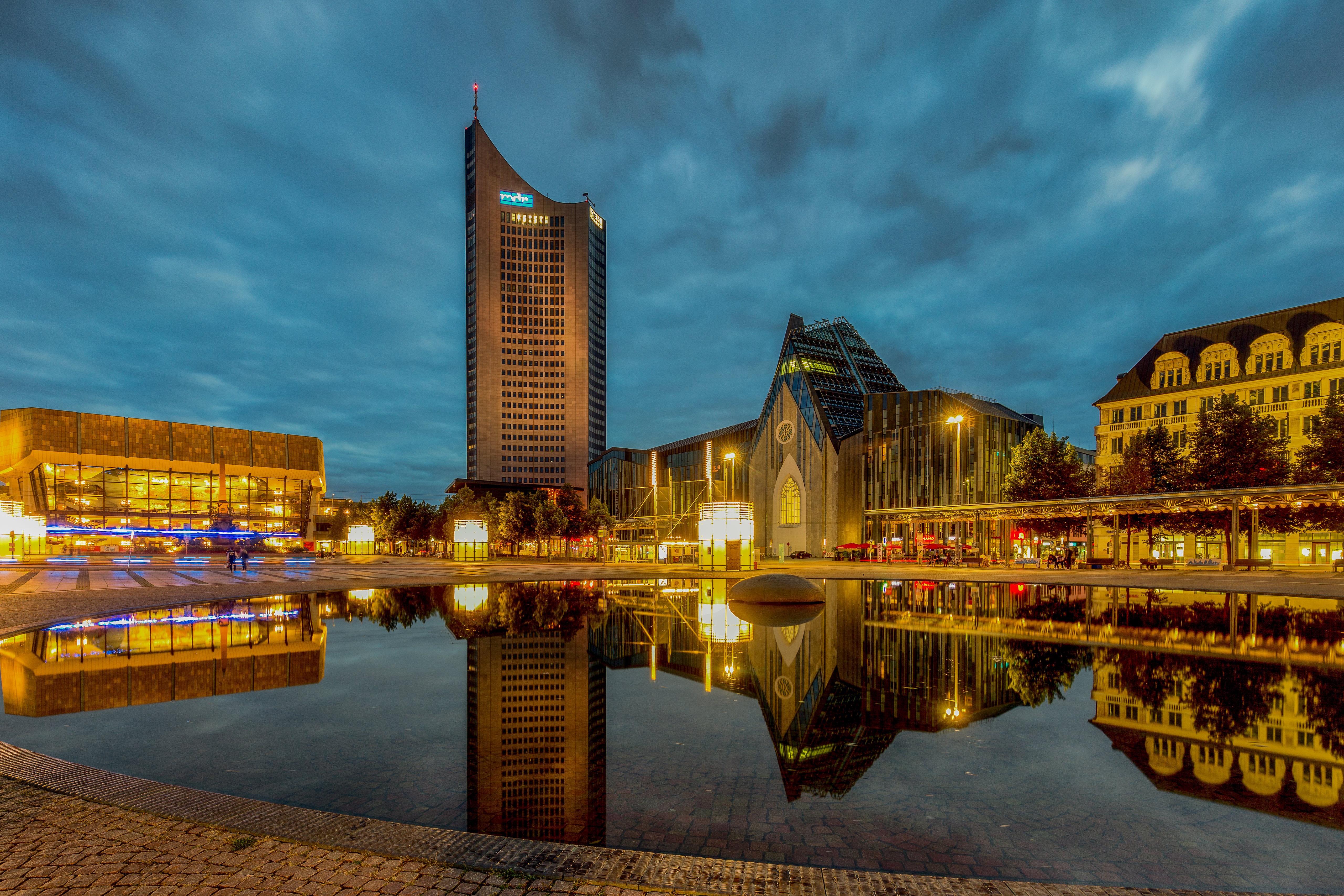 Leipzig town square with modern buildings and reflection at night HD Wallpaper