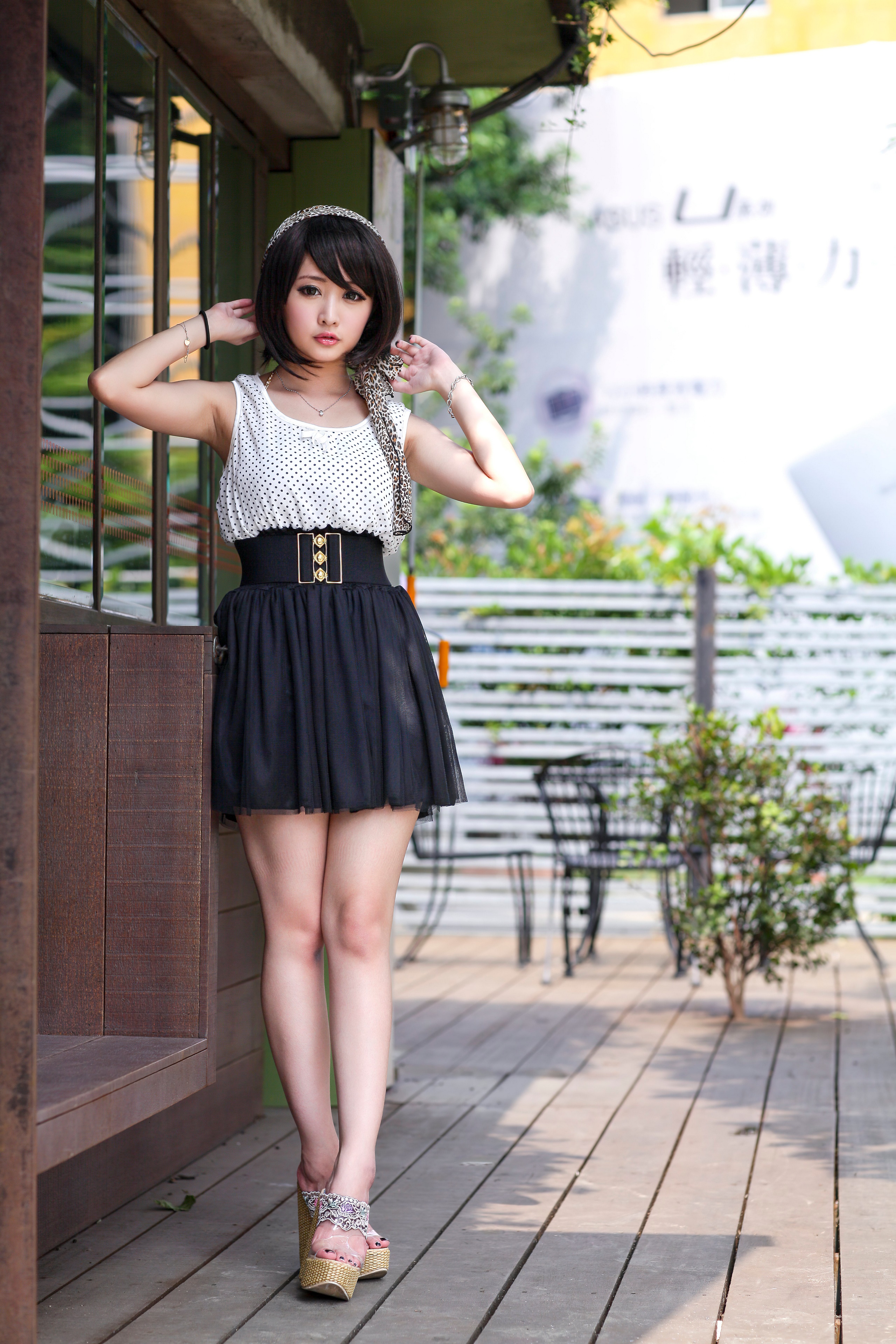 Asian girl in polka dot top and black skirt posing HD Phone Wallpaper