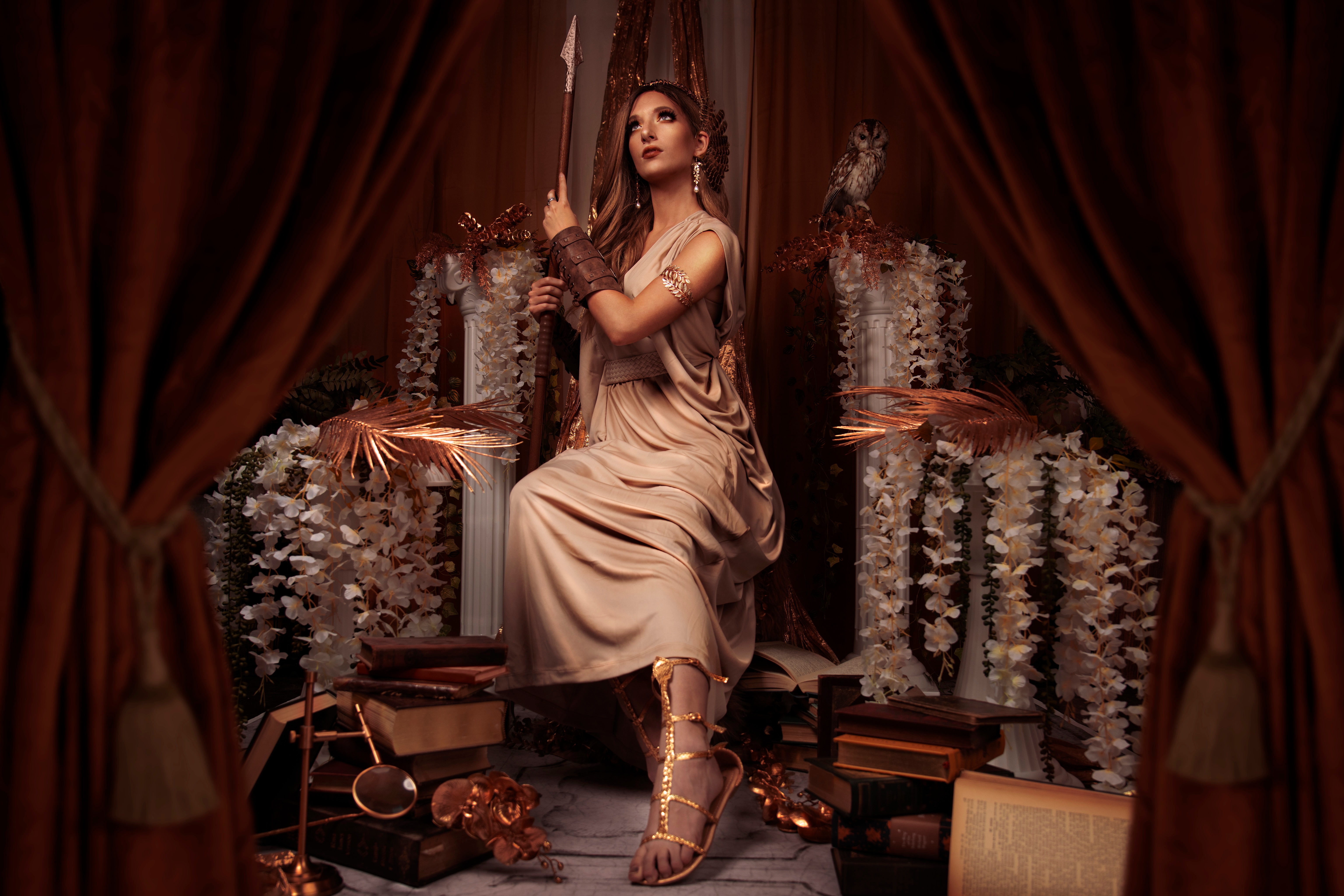 Minerva sitting on a throne with a spear and books HD Wallpaper