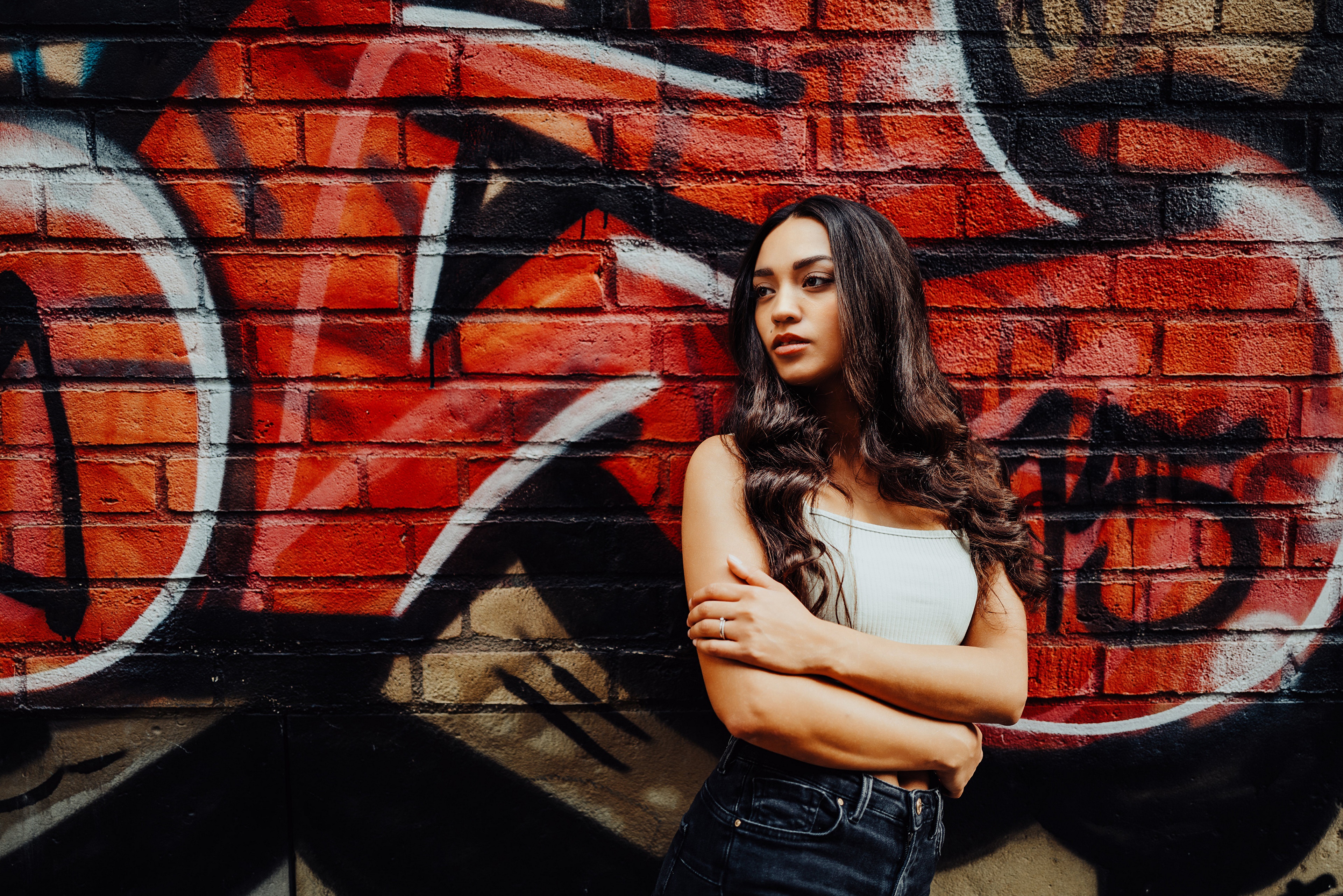 Woman posing against graffiti wall HD Wallpaper