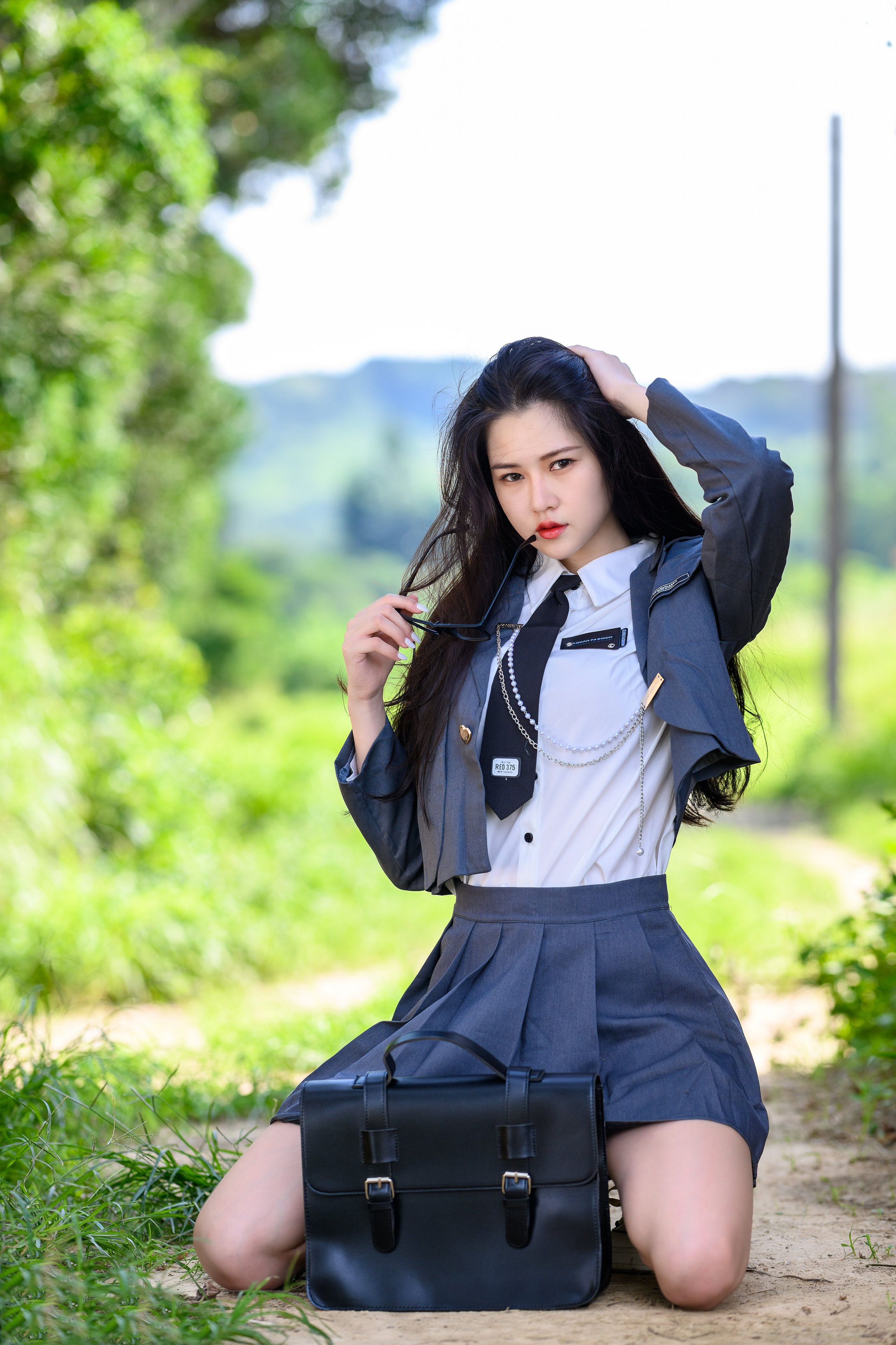 Brunette girl in school uniform posing outdoors HD Phone Wallpaper
