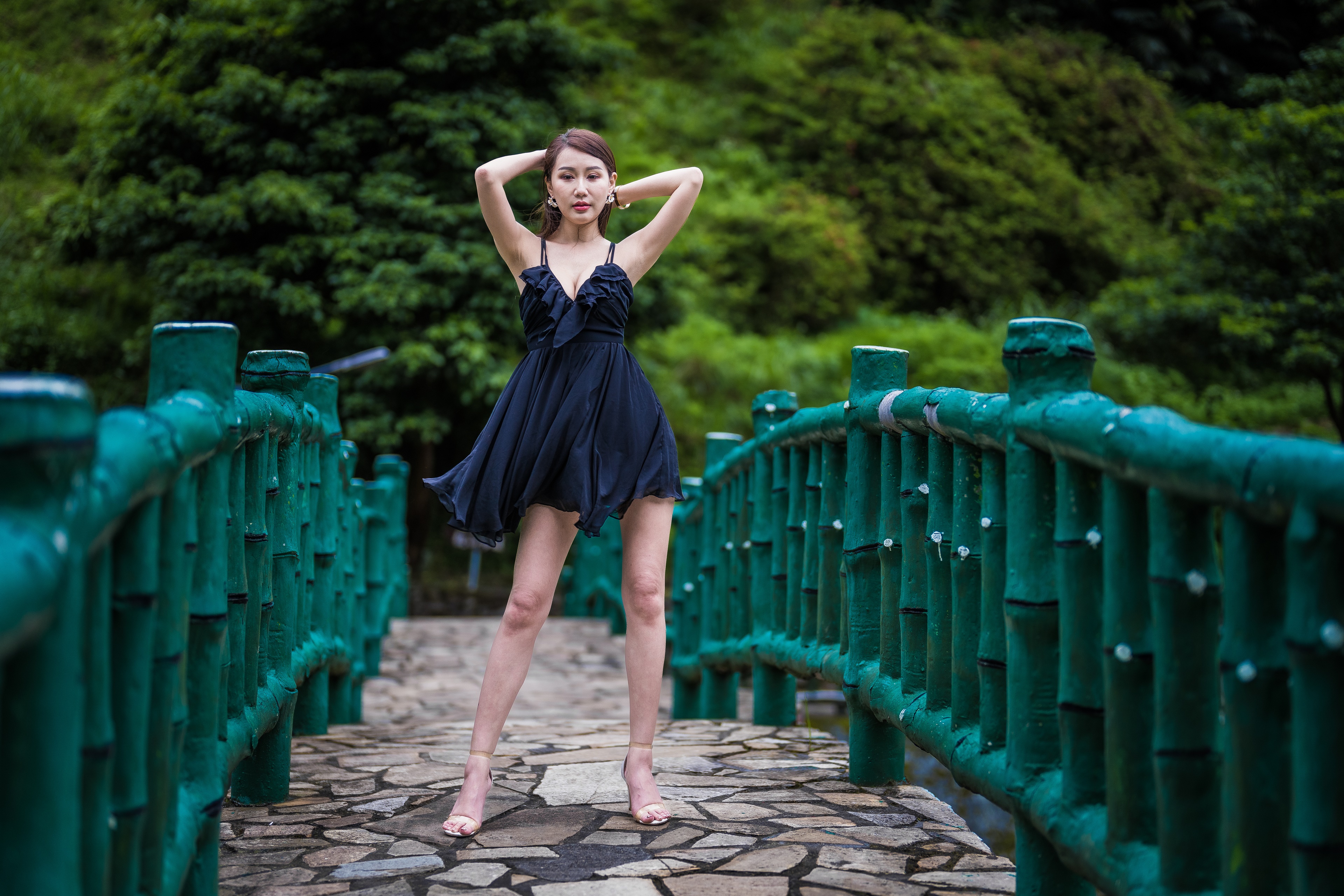 Asian woman in black dress posing on a bridge HD Wallpaper