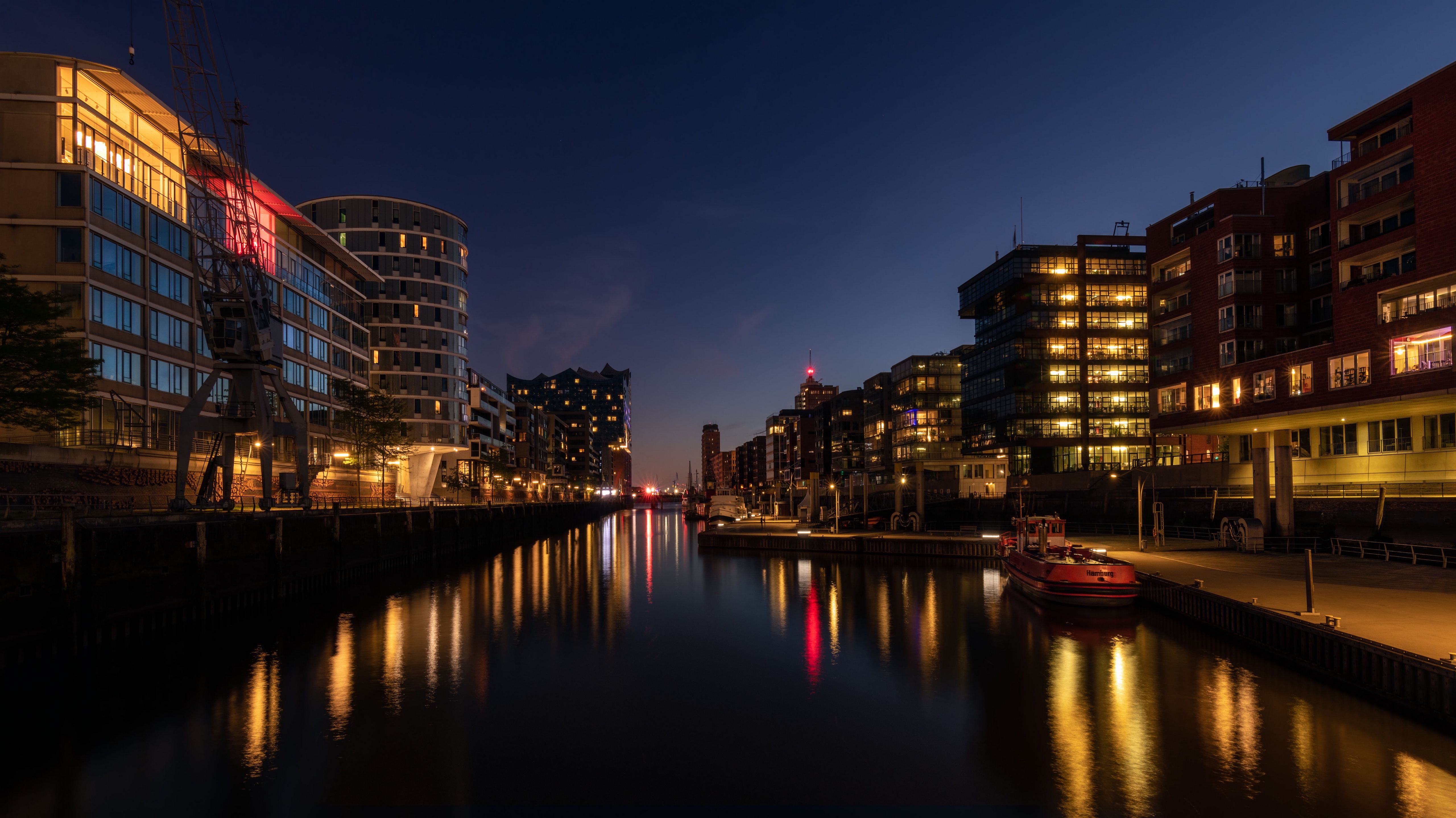 Hamburg canal at night with illuminated buildings HD Wallpaper