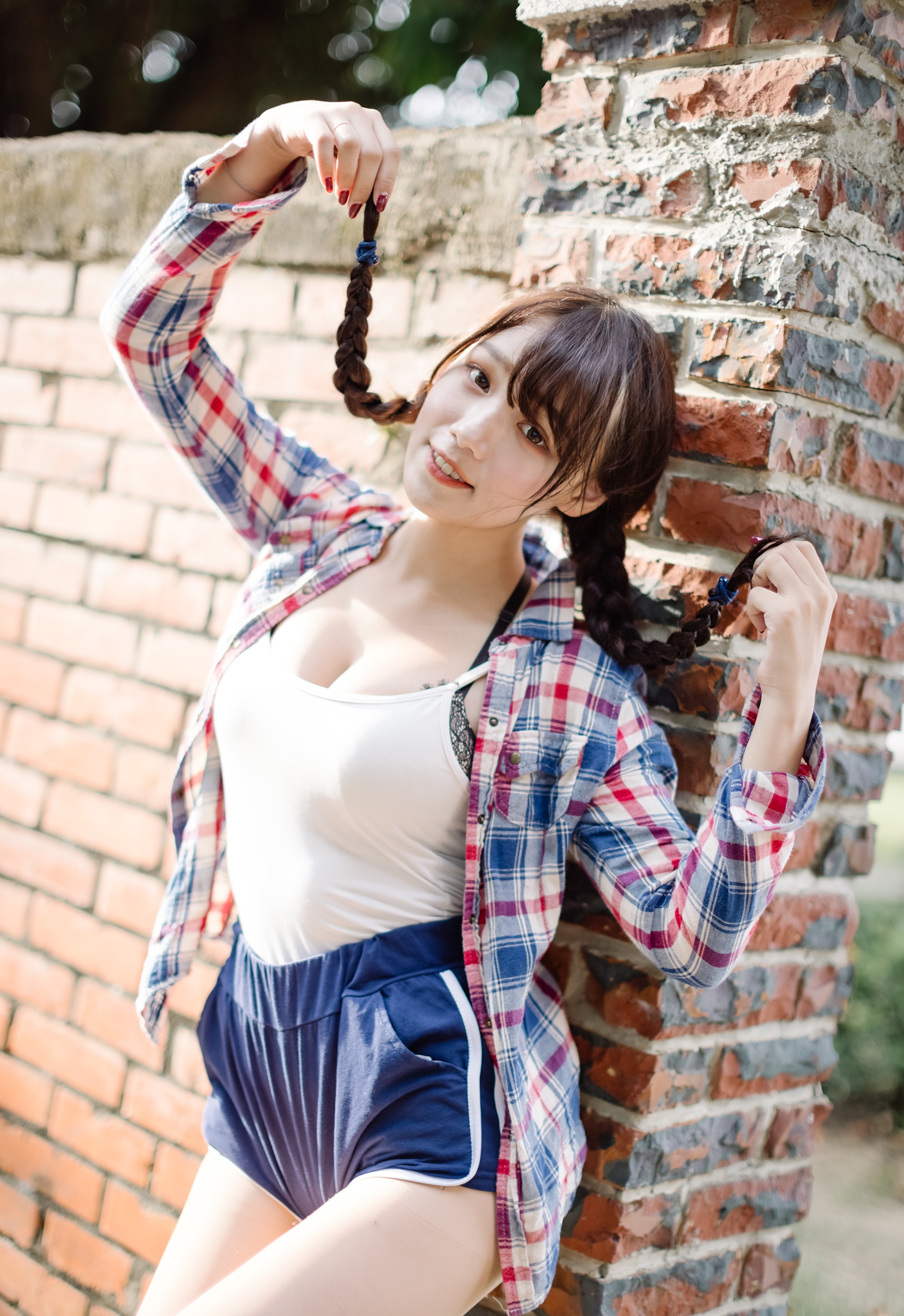 Brunette girl with braids in plaid shirt and shorts HD Phone Wallpaper