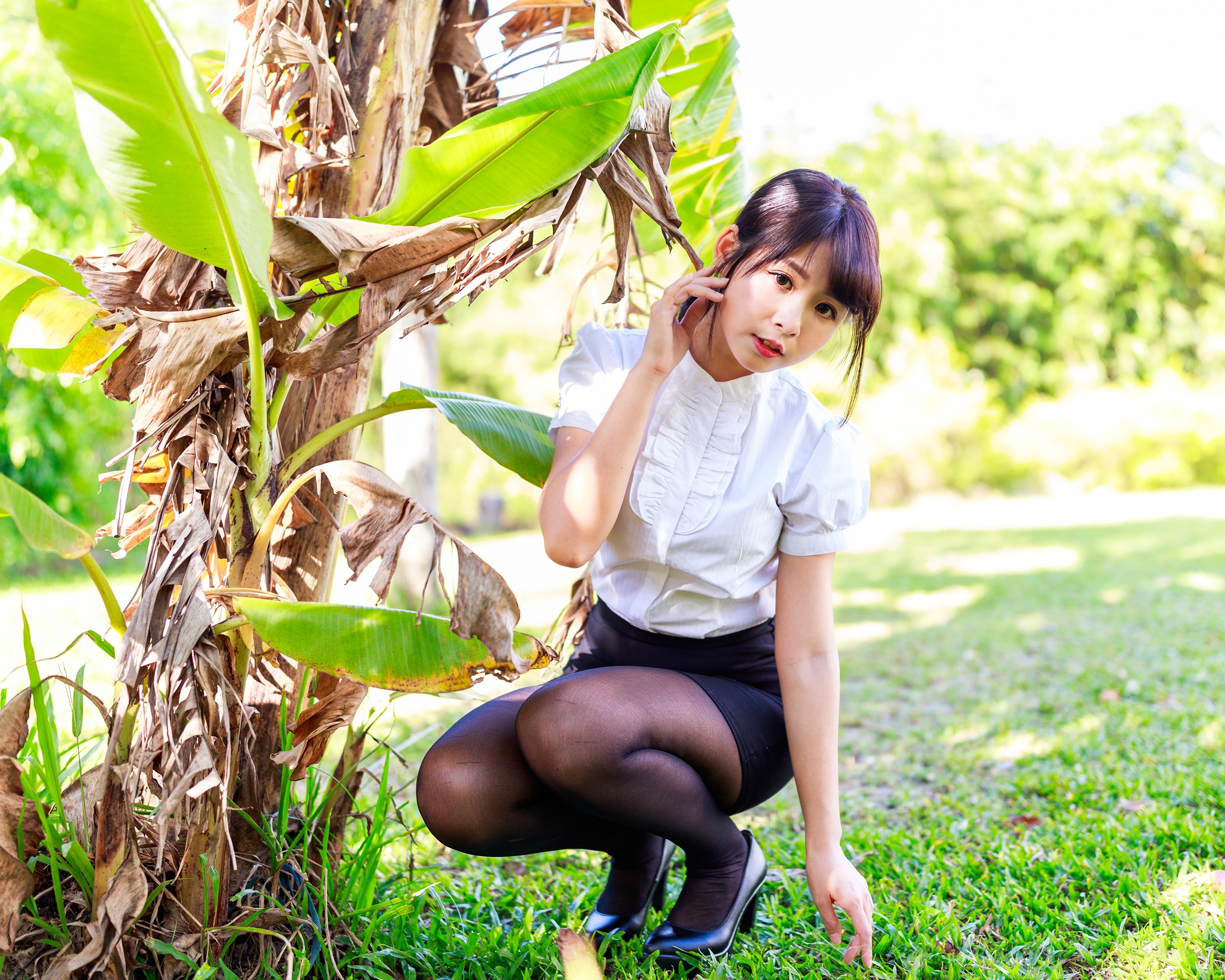 Asian girl in blouse and skirt posing by banana tree HD Wallpaper