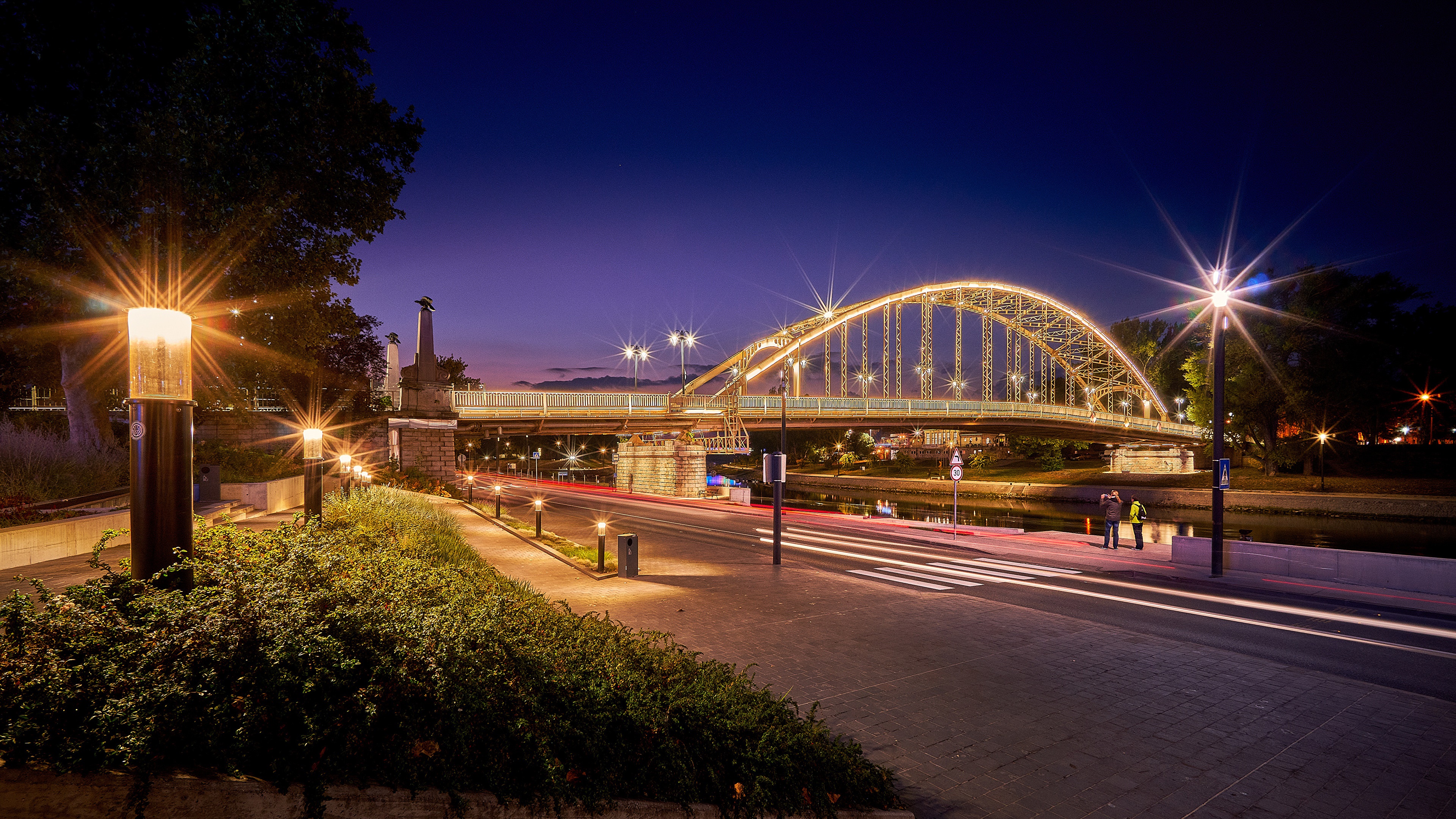 Bridge illuminated at night with street lights HD Wallpaper