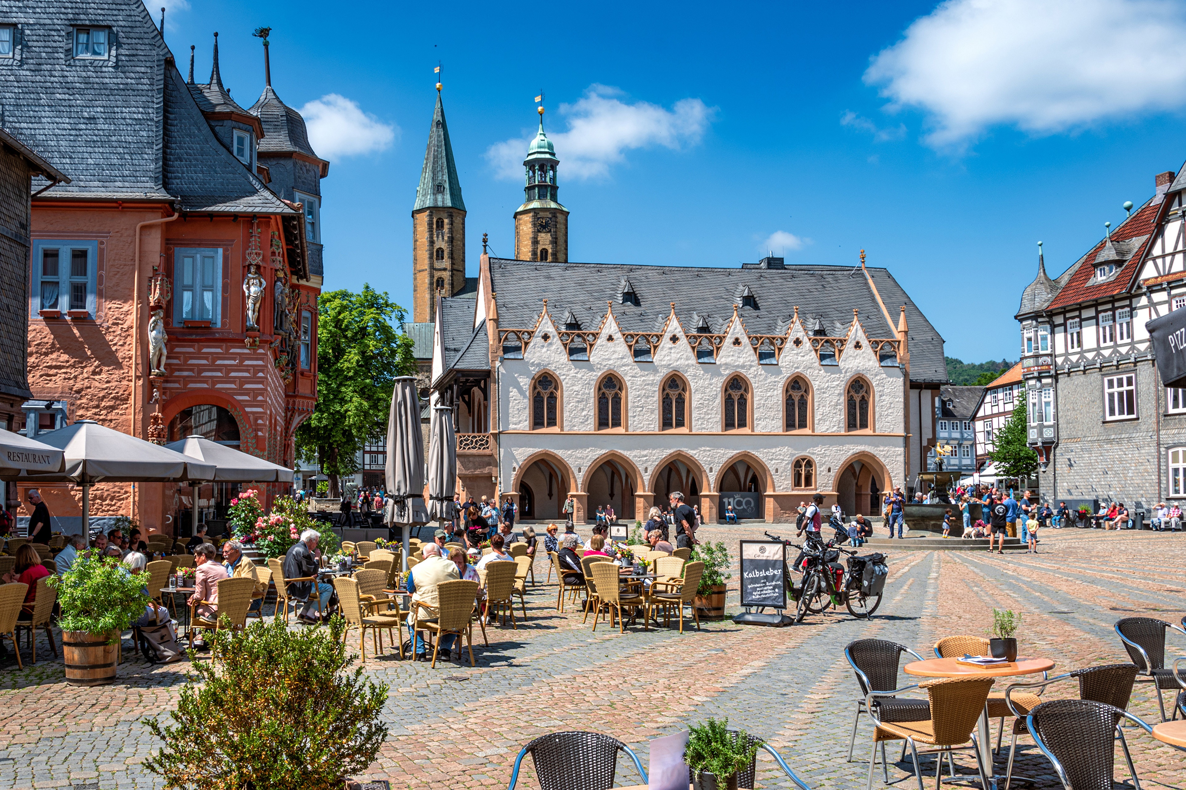 Town square with cafes and historic buildings in Goslar, Germany HD Wallpaper