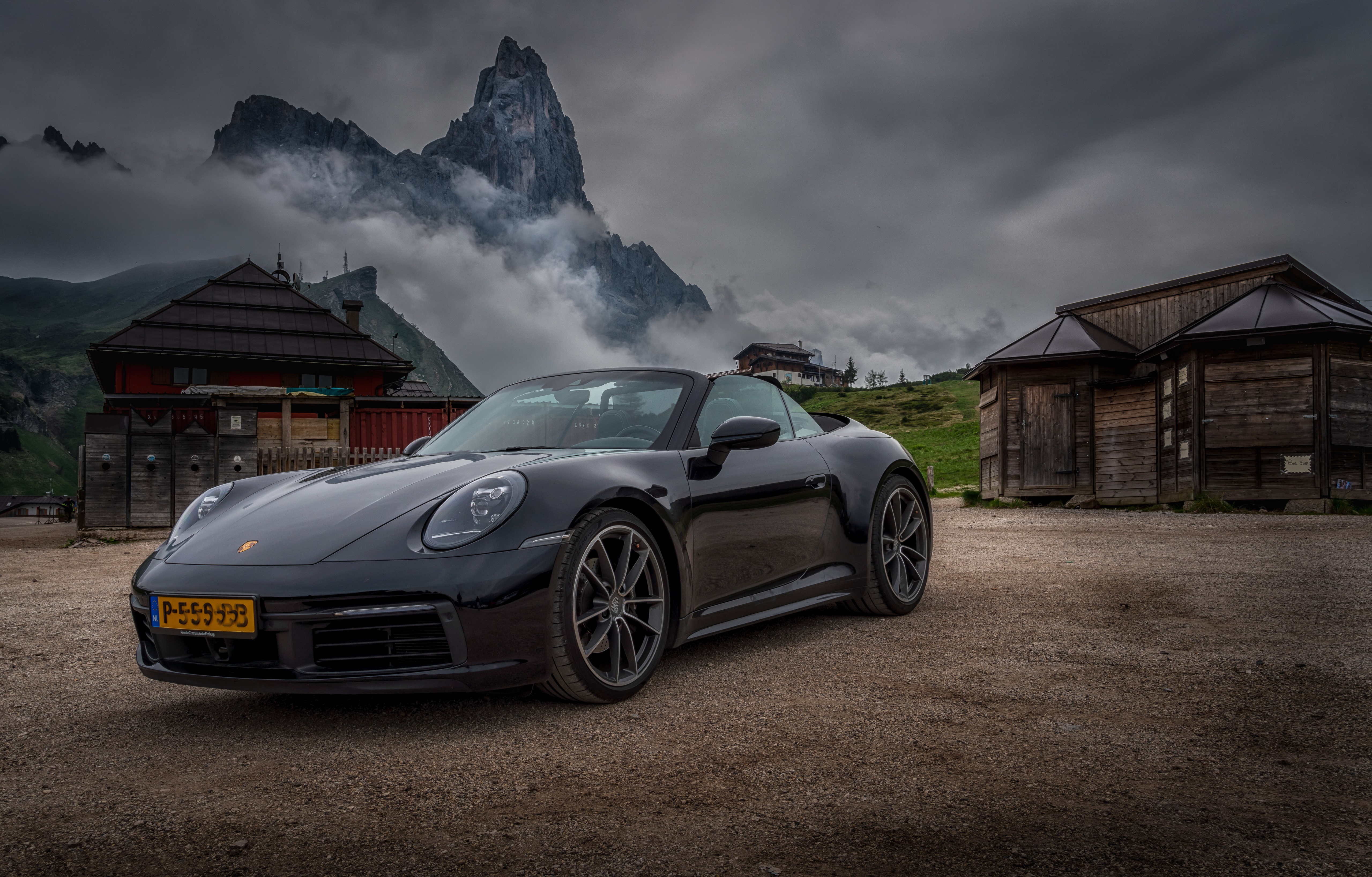 Black Porsche Carrera Cabriolet (992) in Dolomites, Italy HD Wallpaper