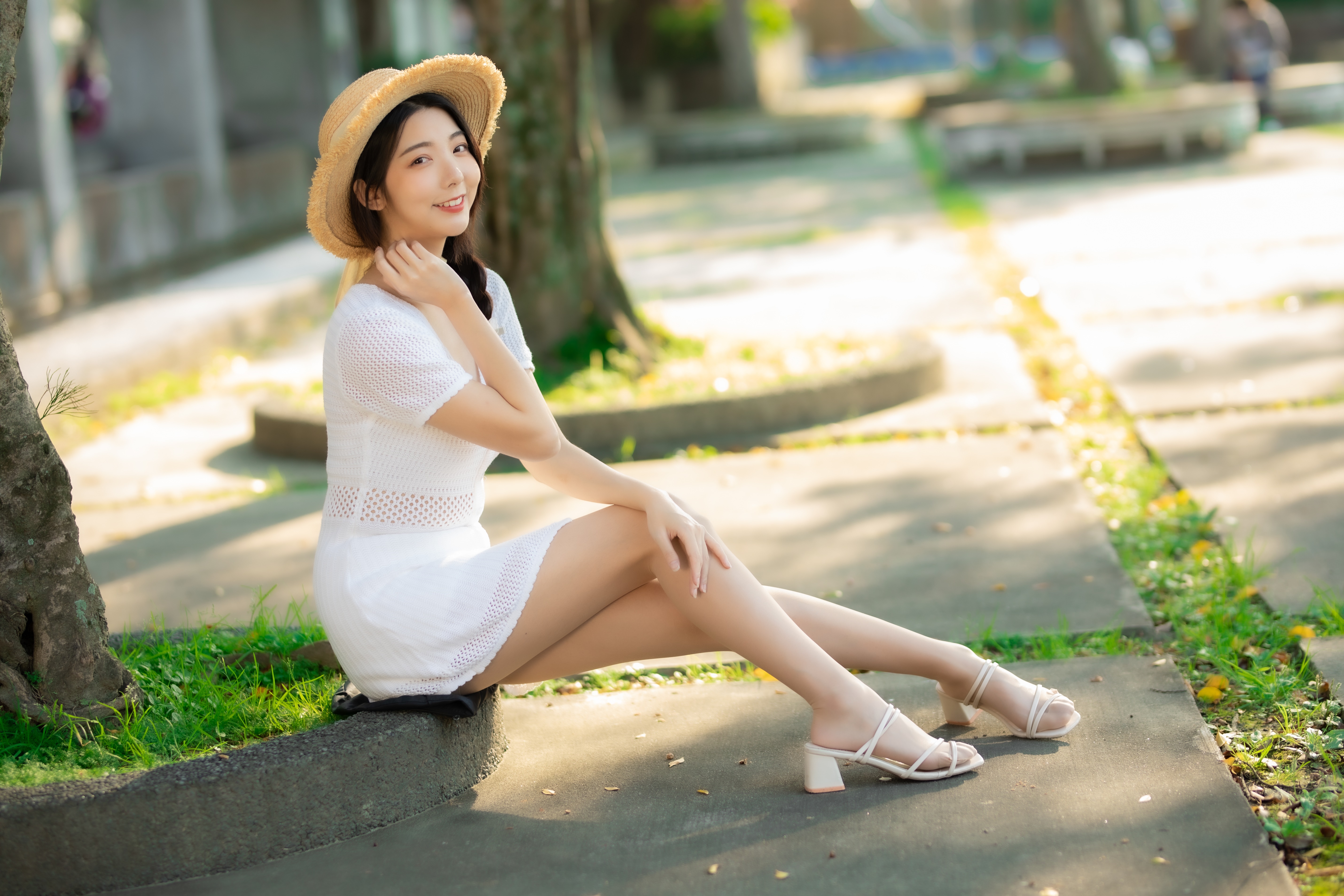 Asian woman in white dress and hat sitting outdoors HD Wallpaper