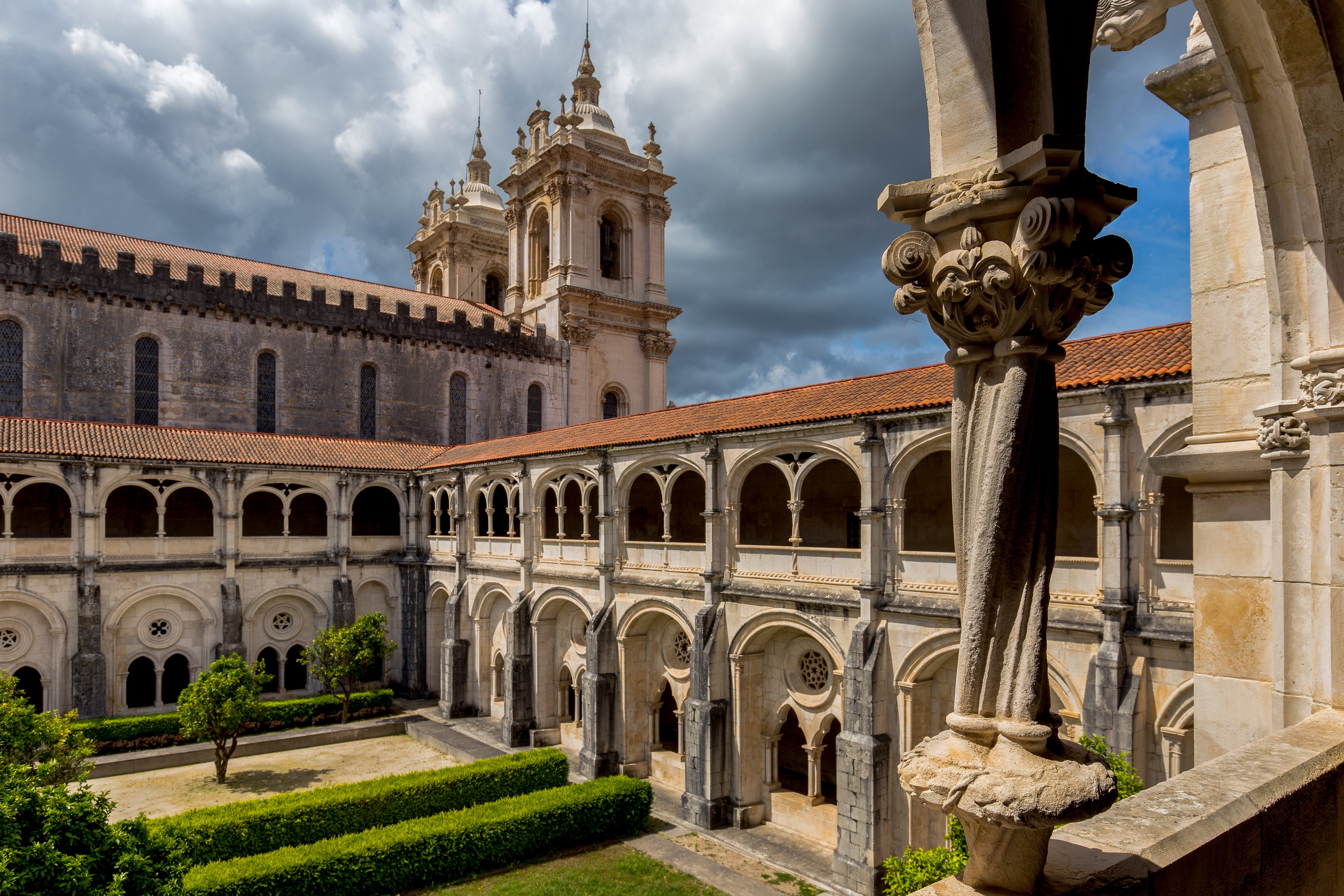Monastery cloister with towers and cloudy sky HD Wallpaper