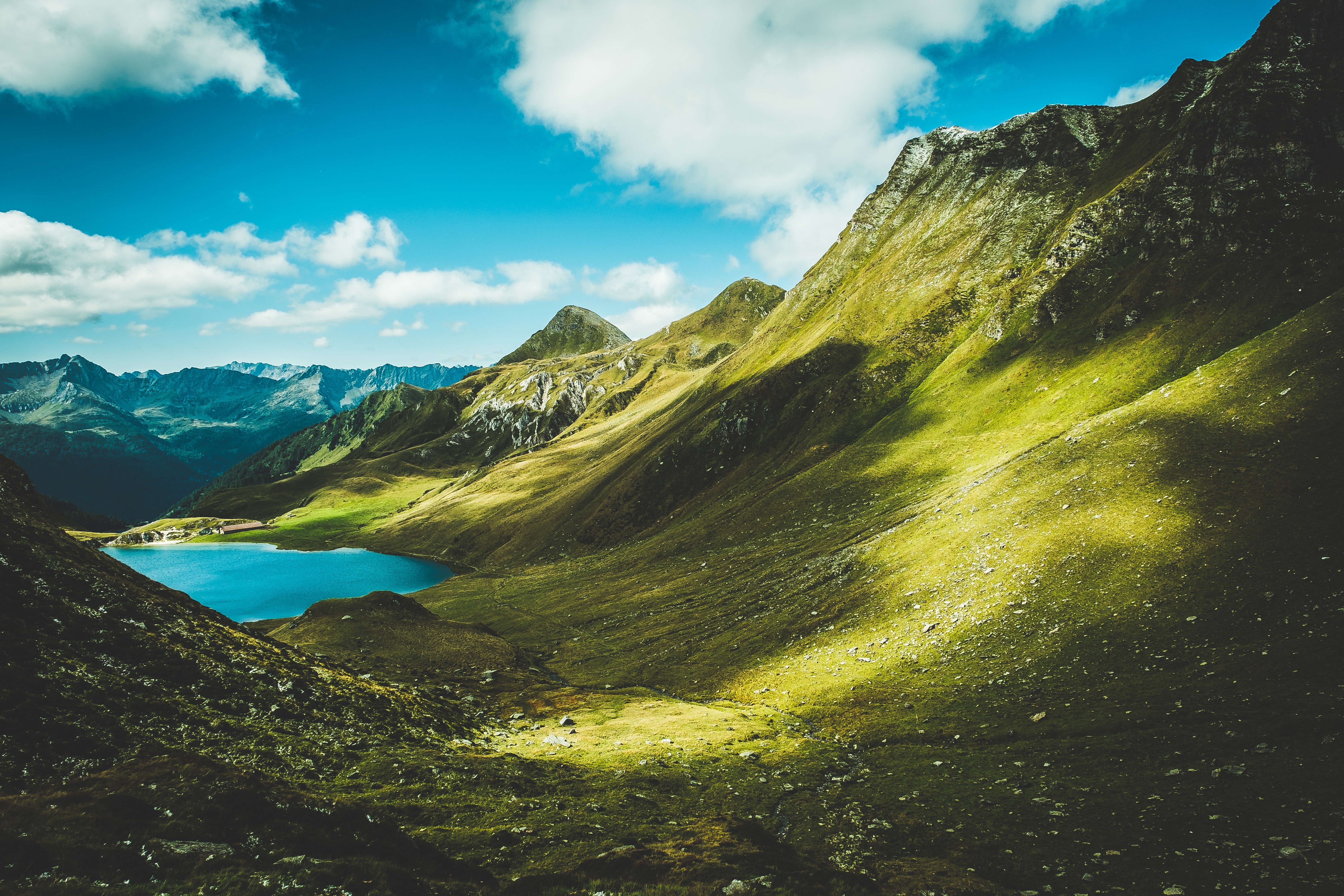 Mountain landscape with a blue lake and green hills HD Wallpaper
