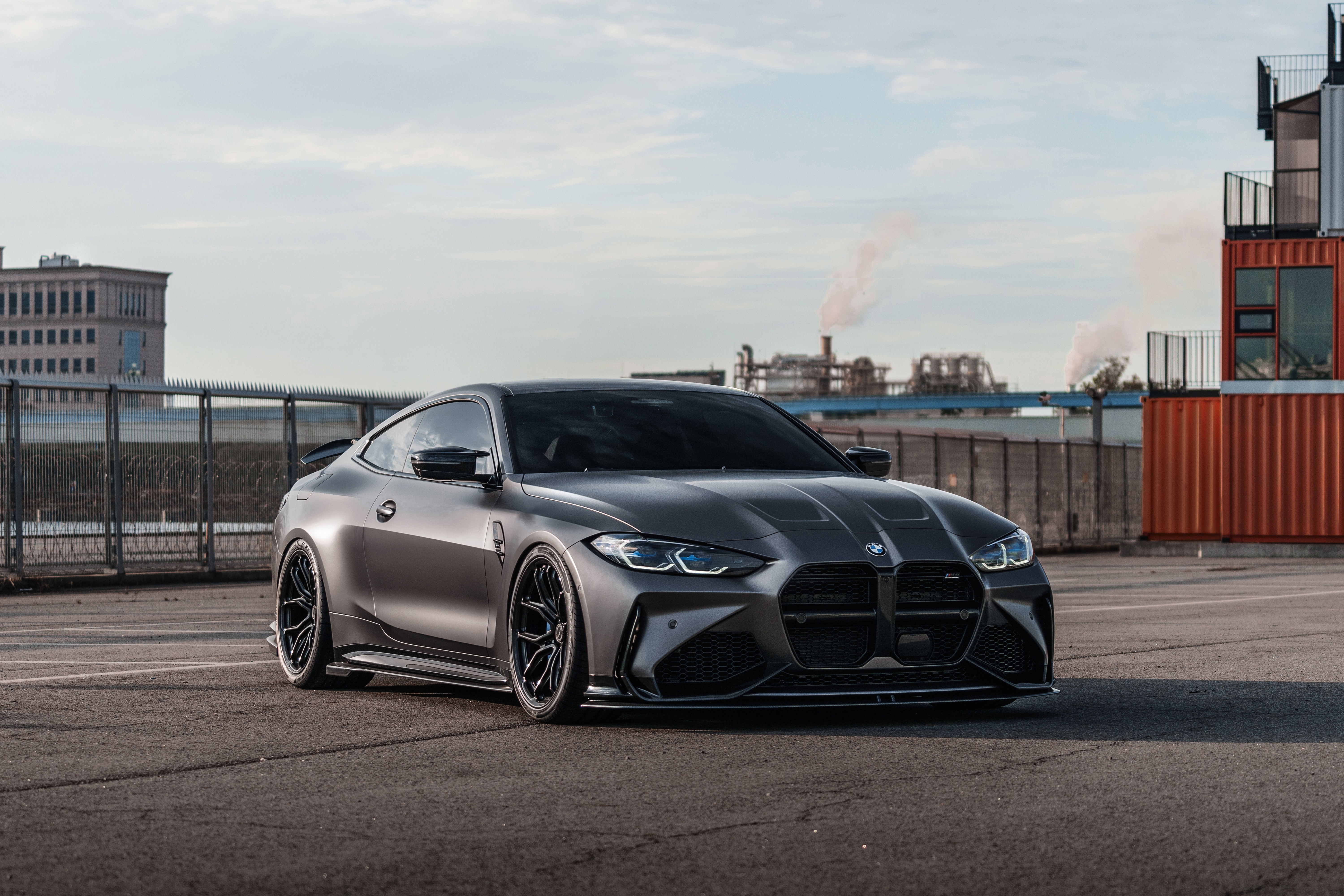 Matte gray BMW M4 coupe on asphalt HD Wallpaper