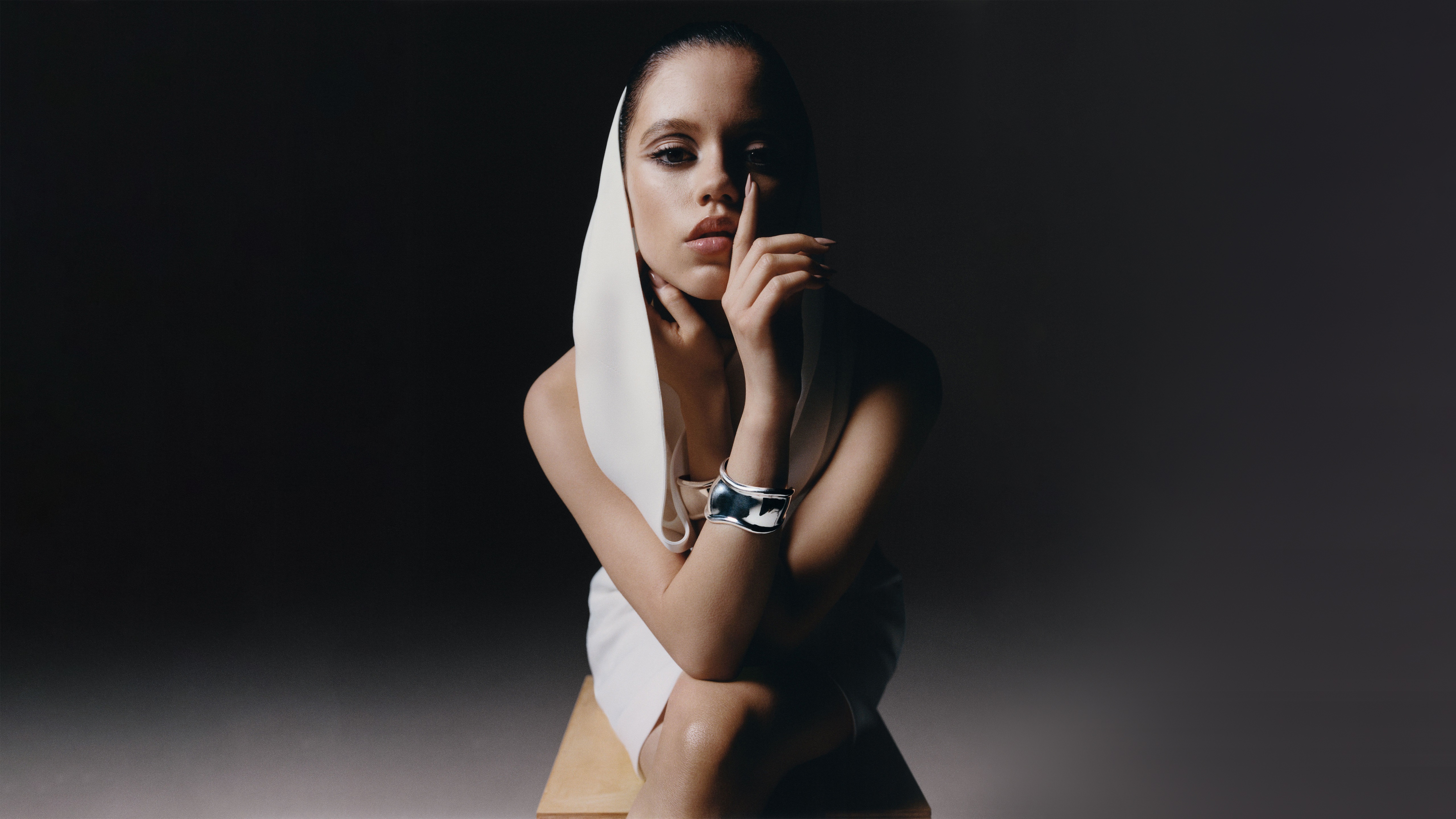 Jenna Ortega posing with a white headscarf and bracelet HD Wallpaper