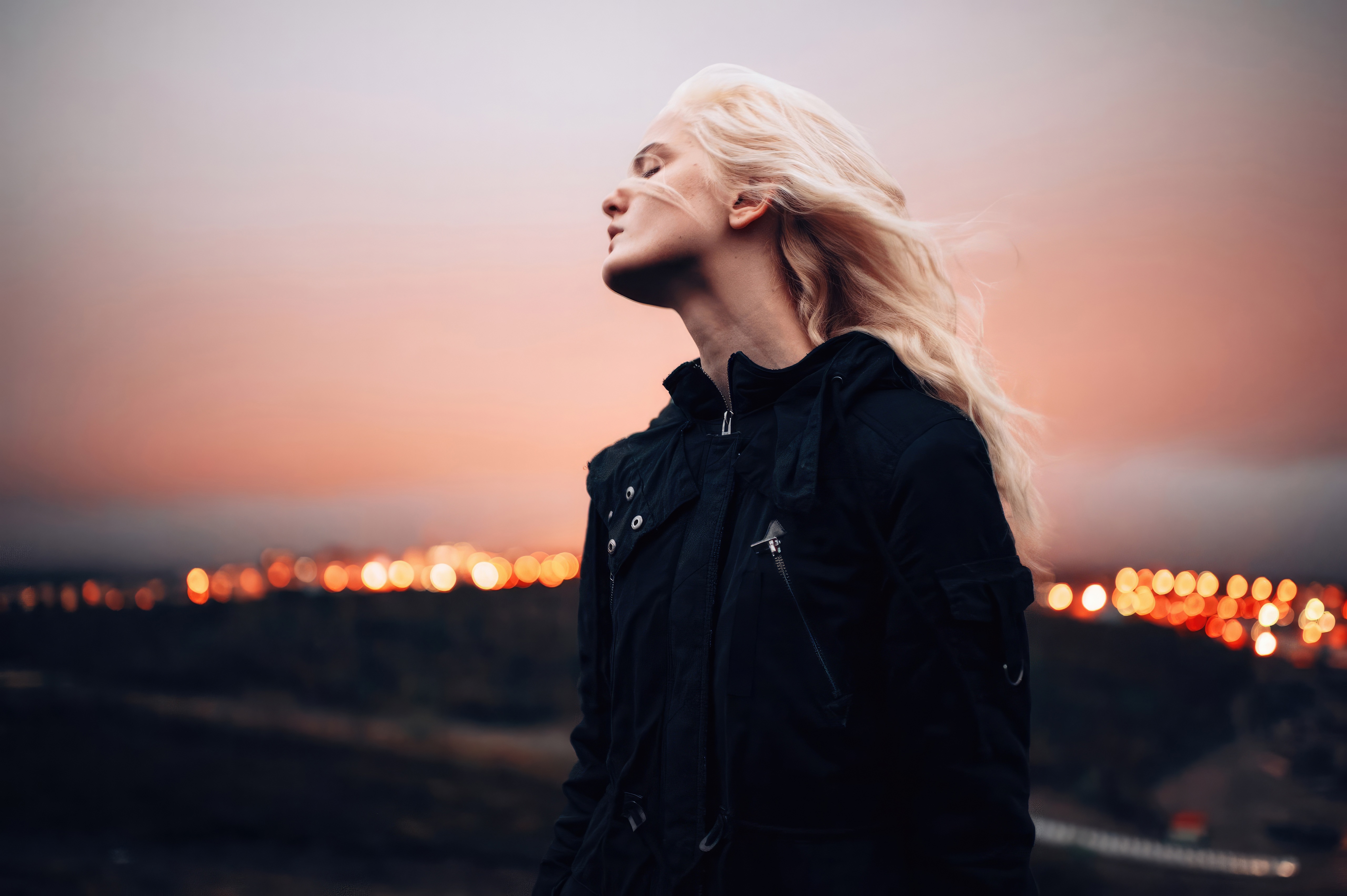 Woman with blonde hair in a black jacket at sunset HD Wallpaper