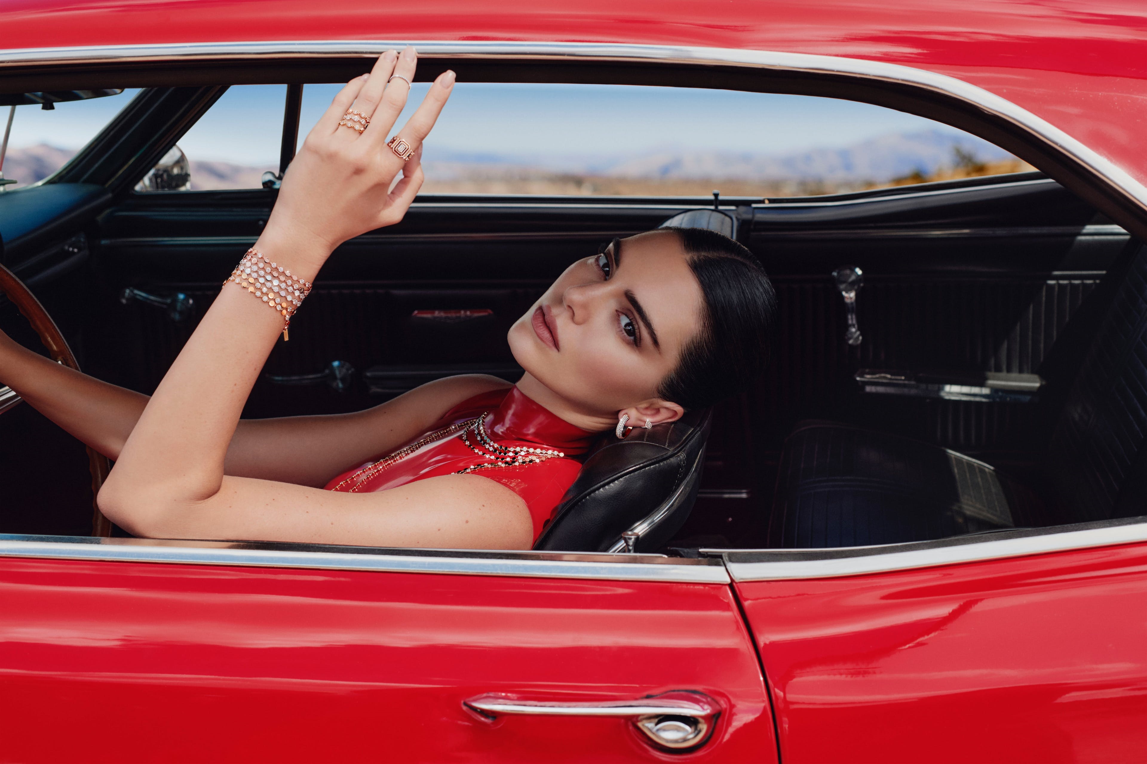 Kendall Jenner in a red dress in a car HD Wallpaper