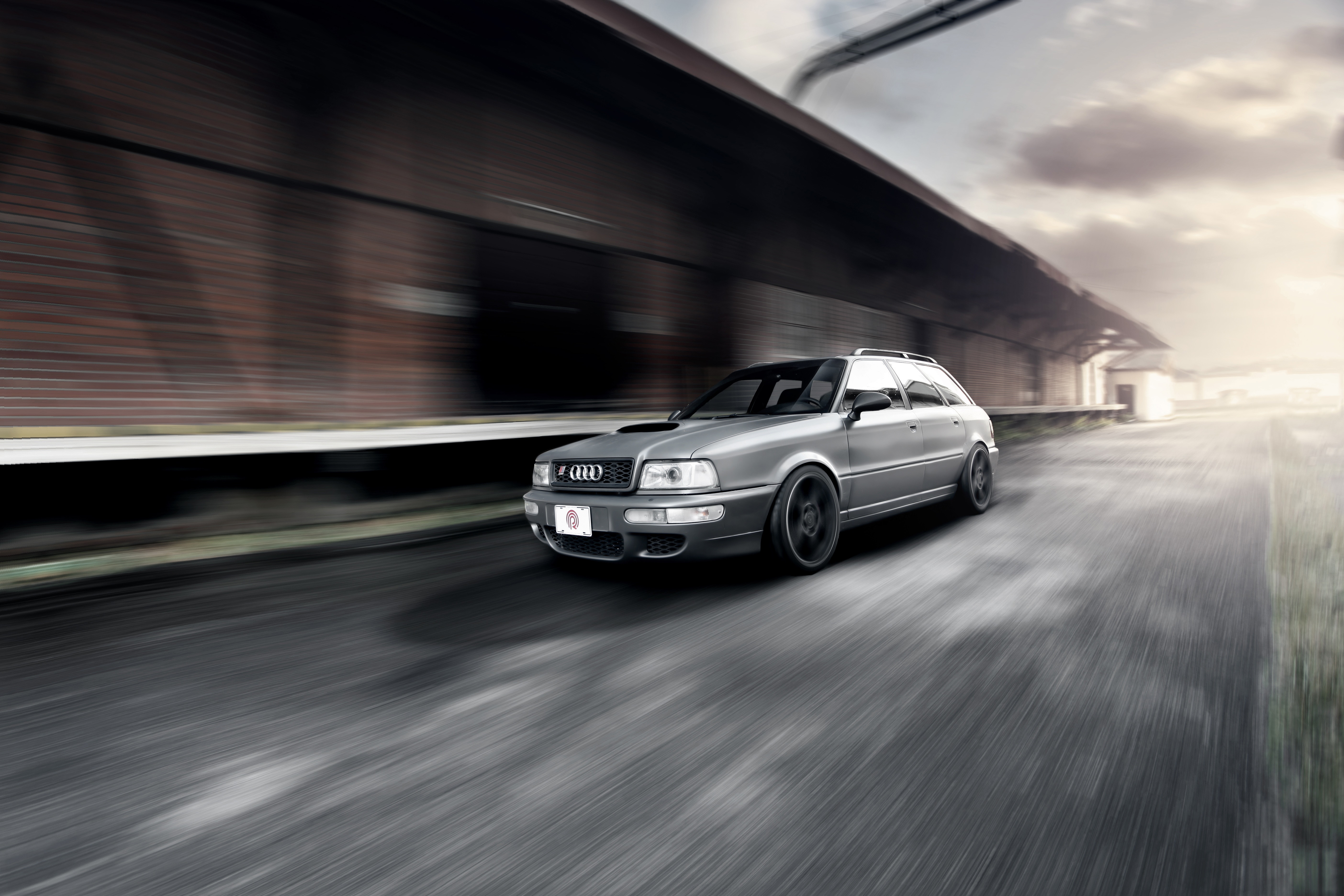 Audi RS2 Avant driving on a road HD Wallpaper