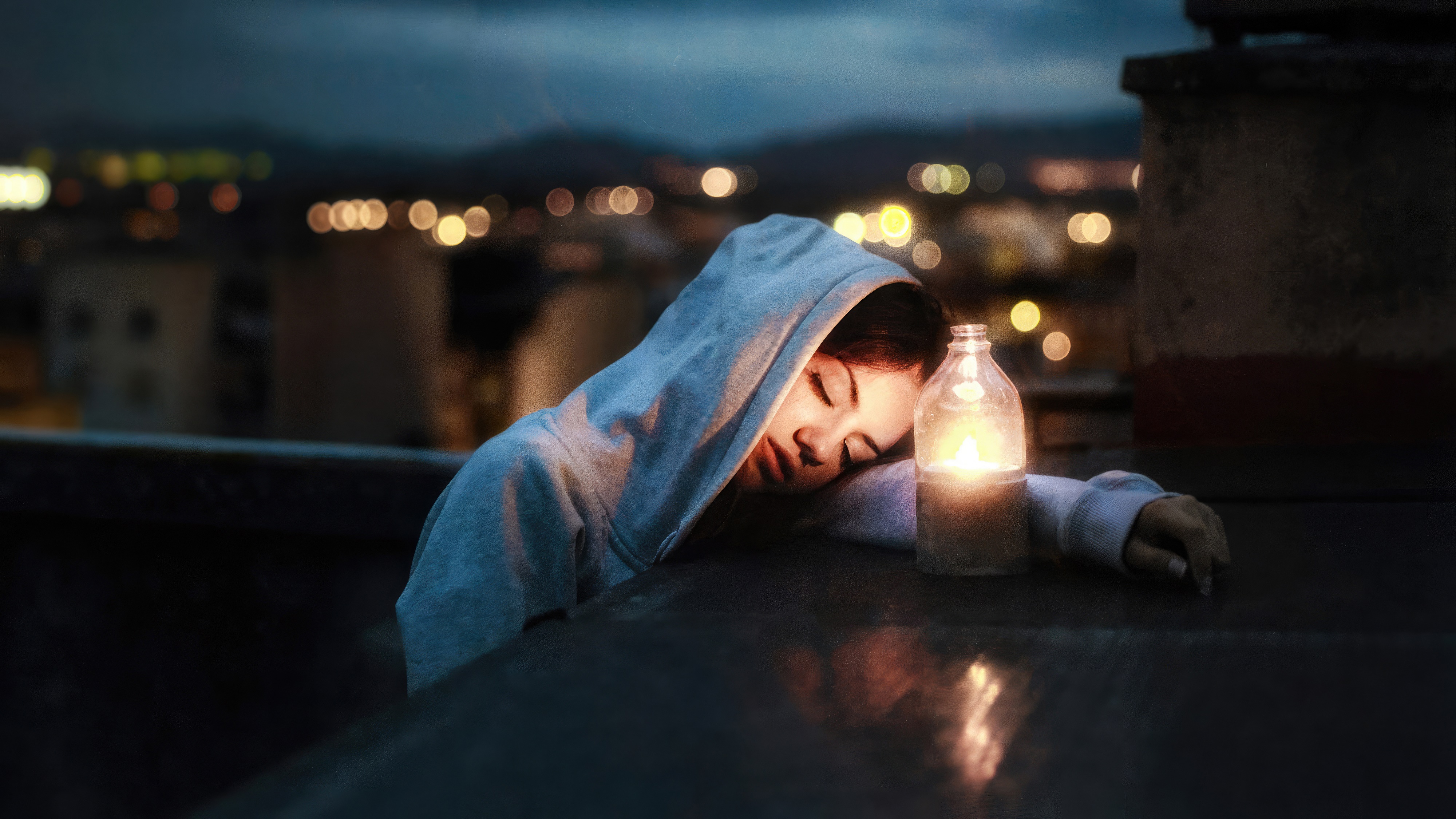 Girl in hoodie with candle on rooftop at night HD Wallpaper