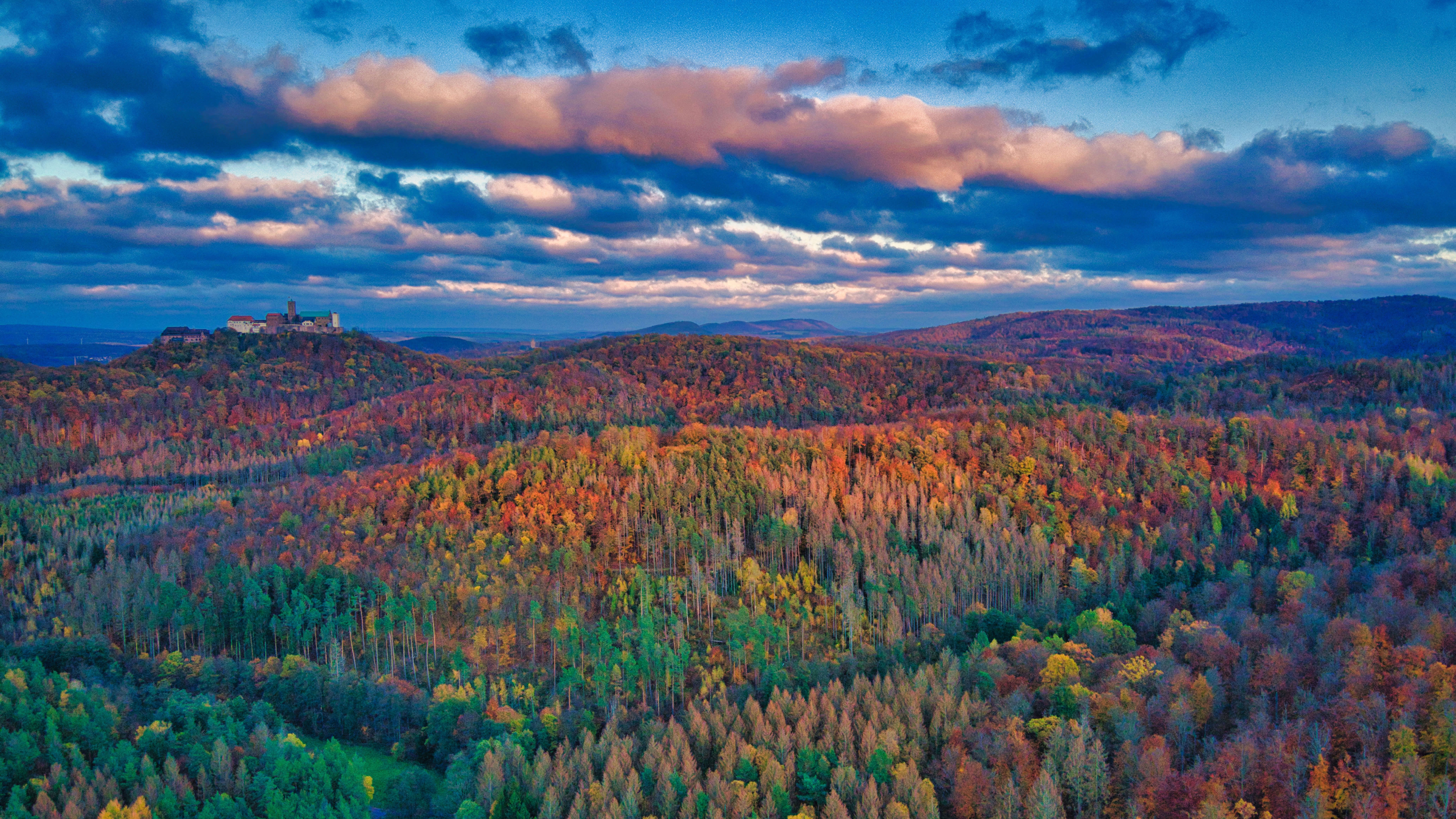 Castle on a hill overlooking autumn forest HD Wallpaper