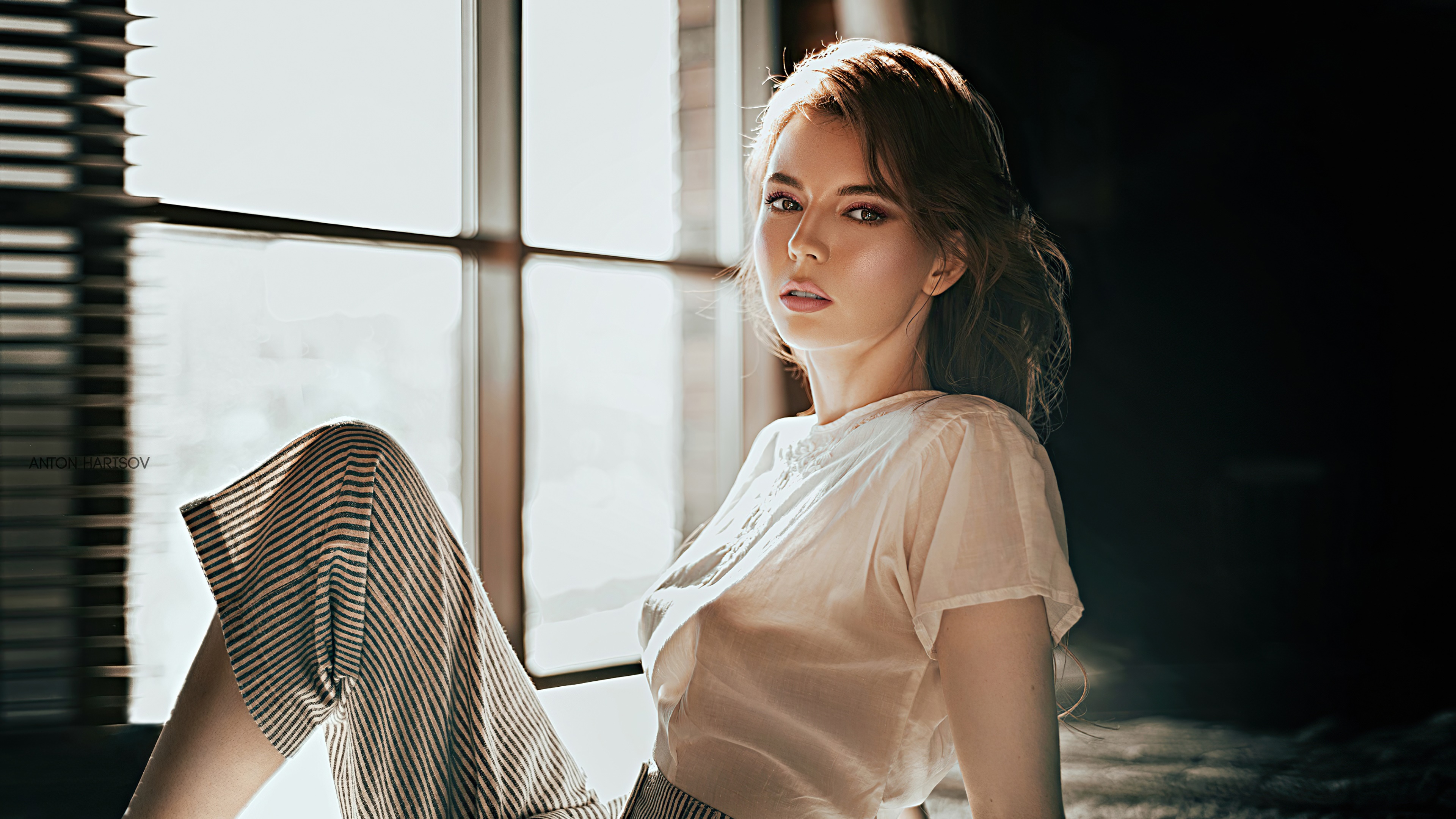 Model in sheer top and striped pants by window HD Wallpaper