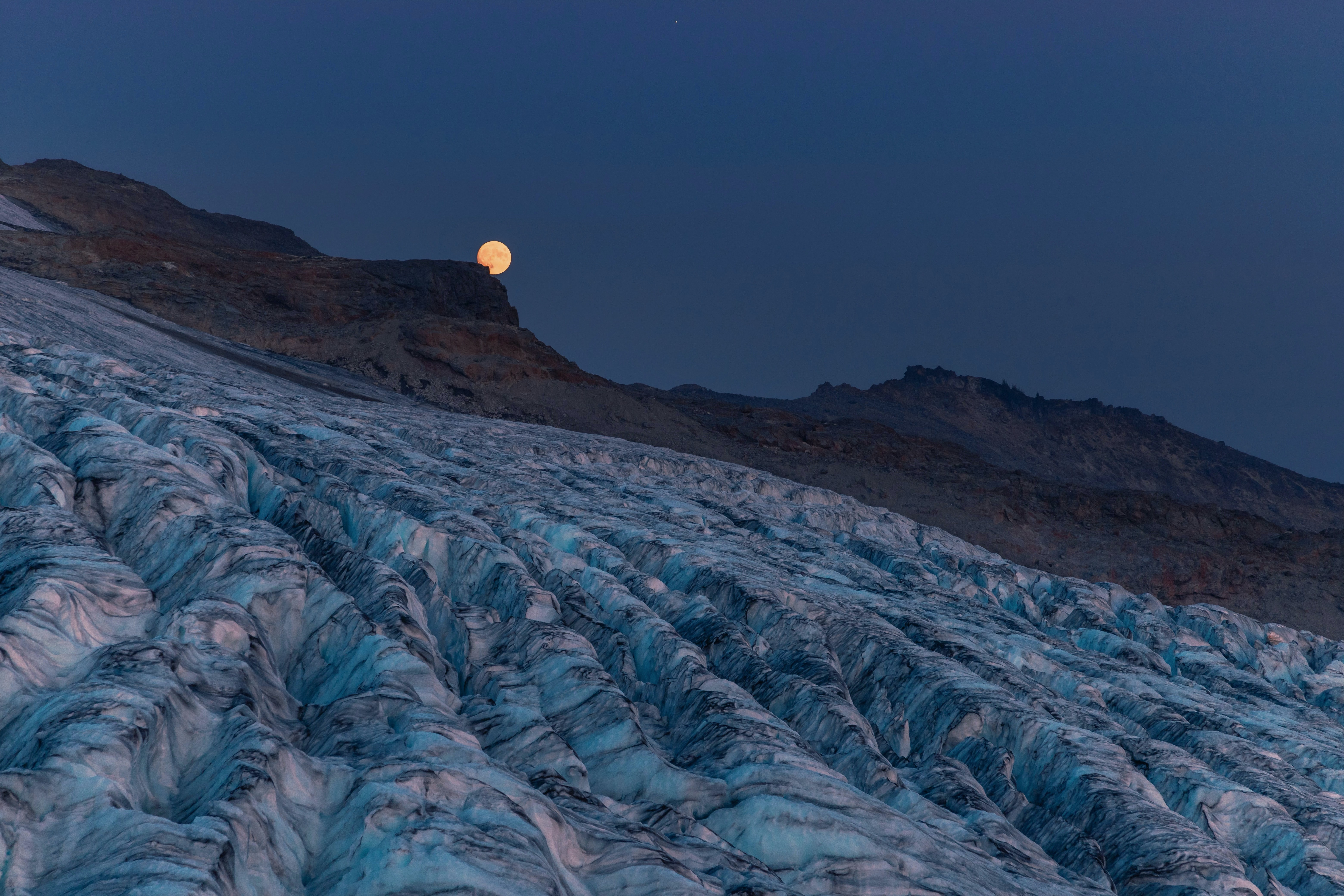 Moon rising over a glacier and mountains HD Wallpaper