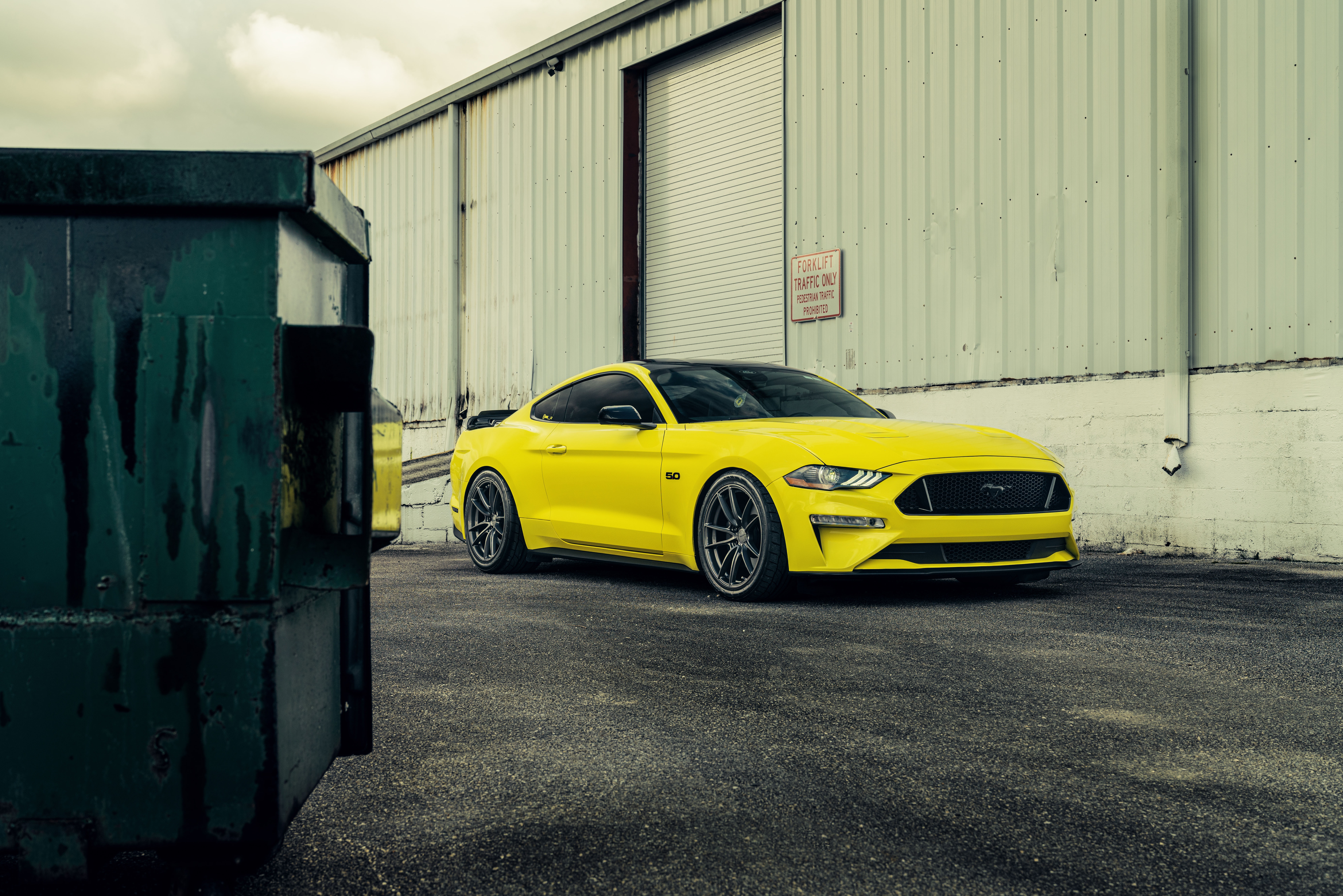 Yellow Ford Mustang GT parked near a building HD Wallpaper