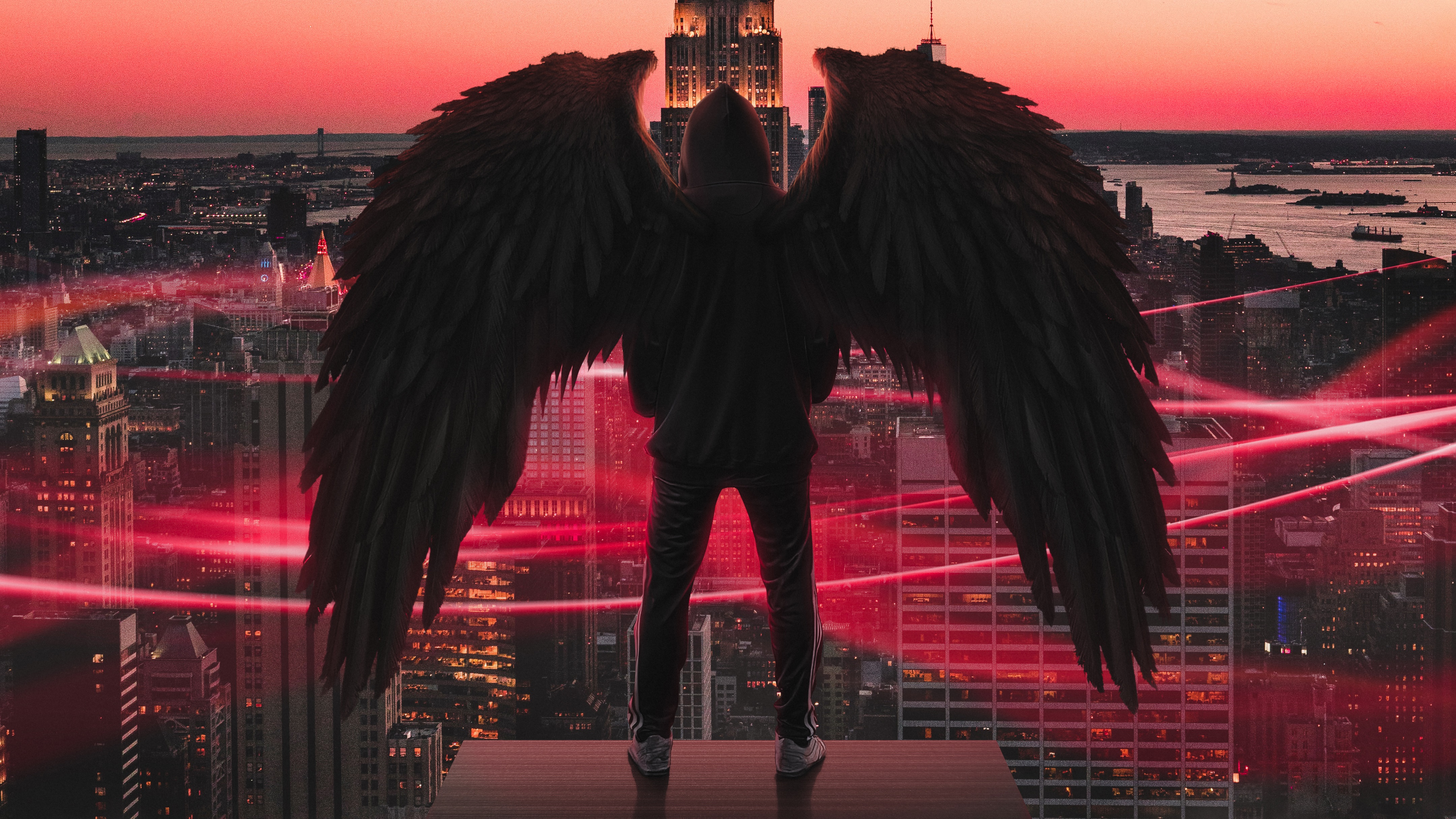 Angel with wings overlooking city at sunset HD Wallpaper